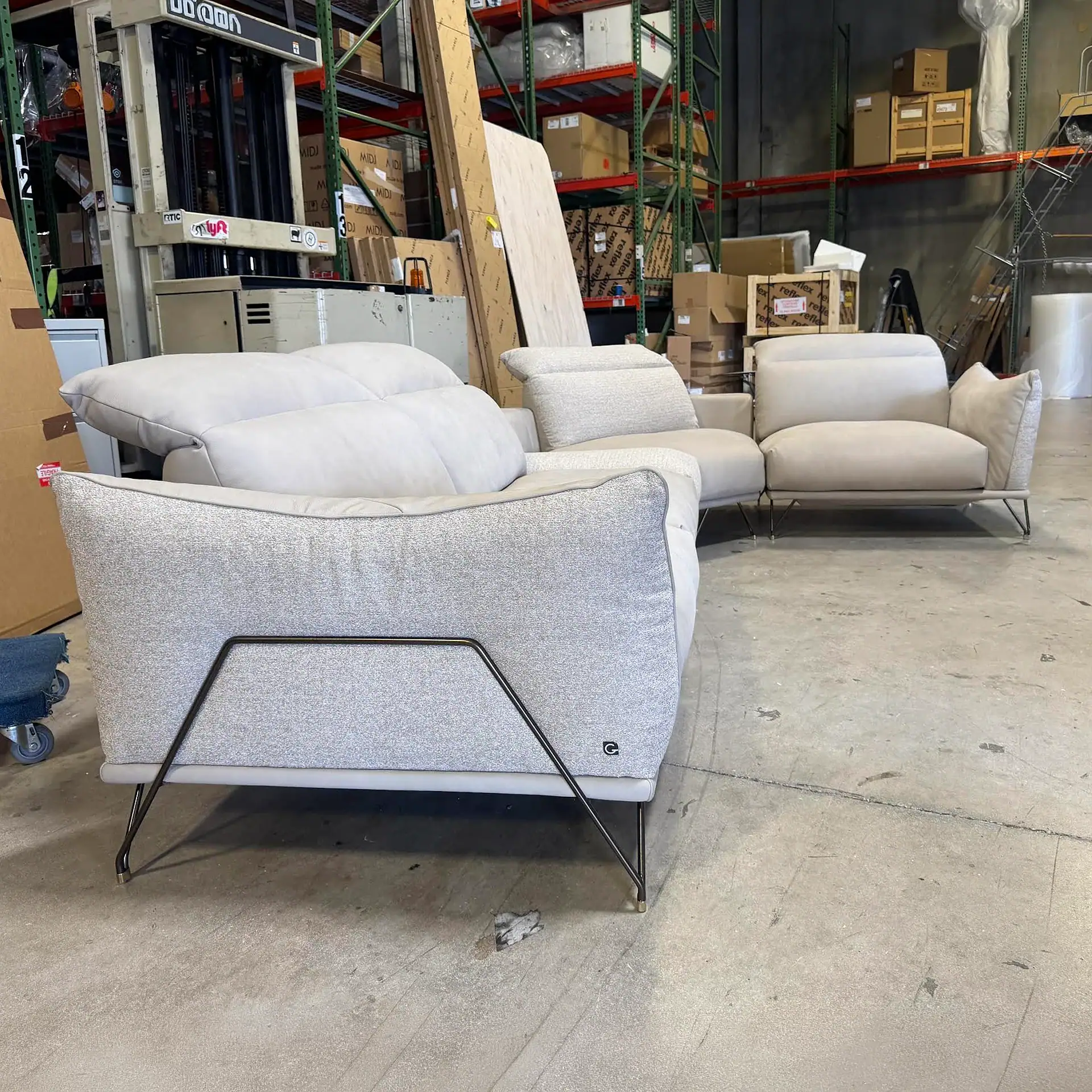 Gorini Dagor sectional sofa in warehouse setting with storage shelves and boxes.
