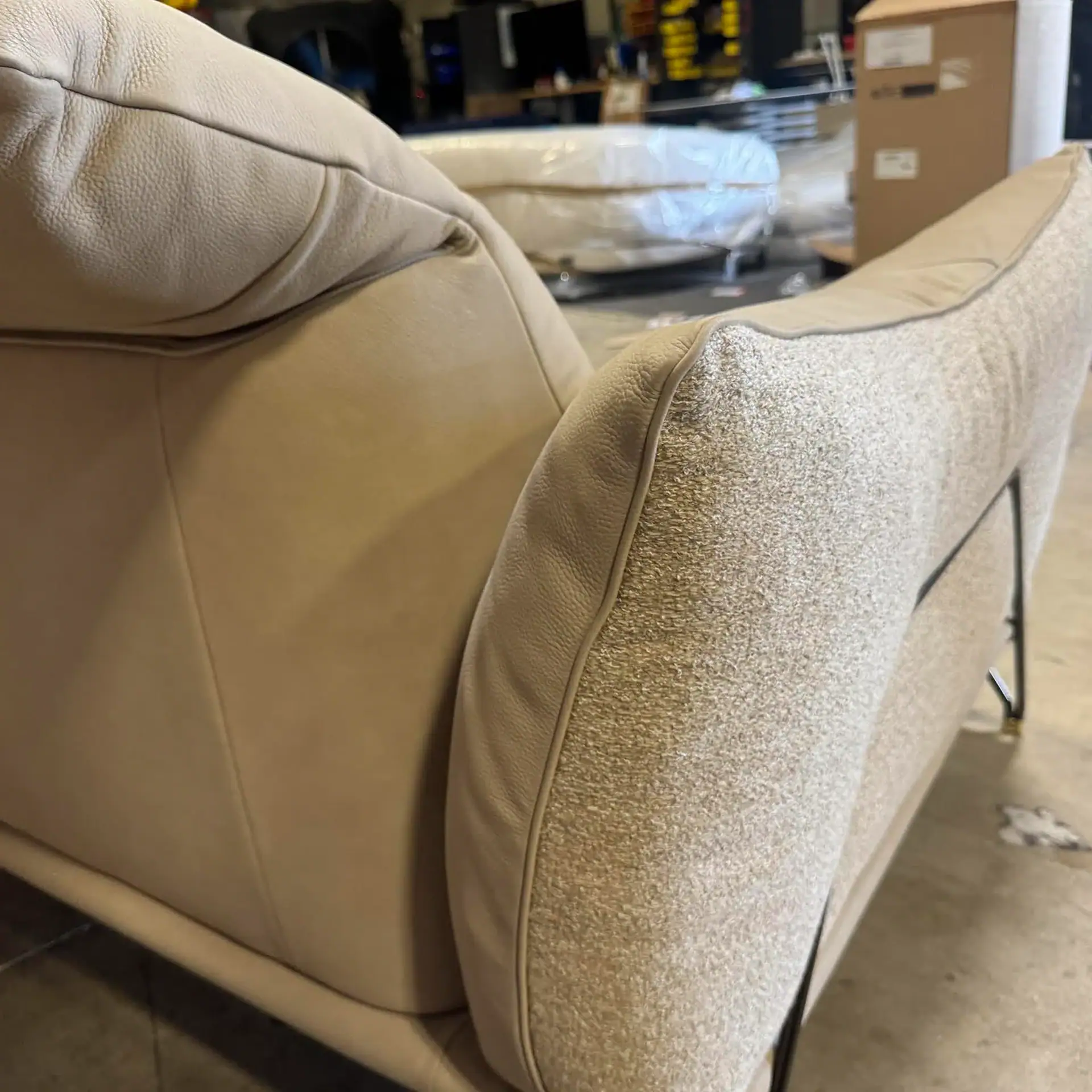 Close-up of the armrest of the Gorini Dagor sectional sofa in a showroom.