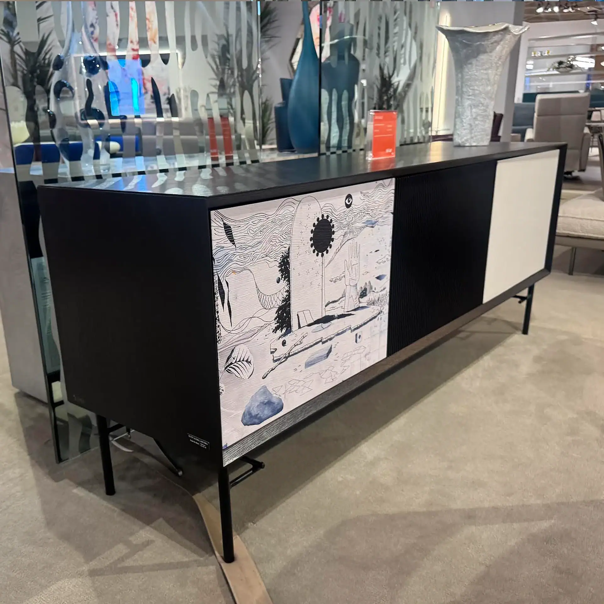 Sklar Furnishings sideboard with artistic design on one door in a furniture store.
