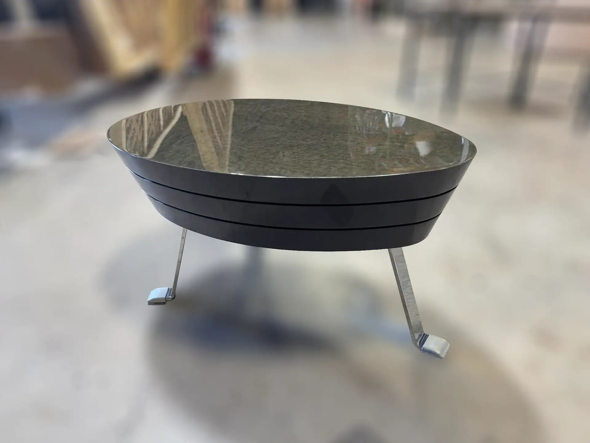 Sklar Furnishings John Low Table with a dark stone top and metal legs.