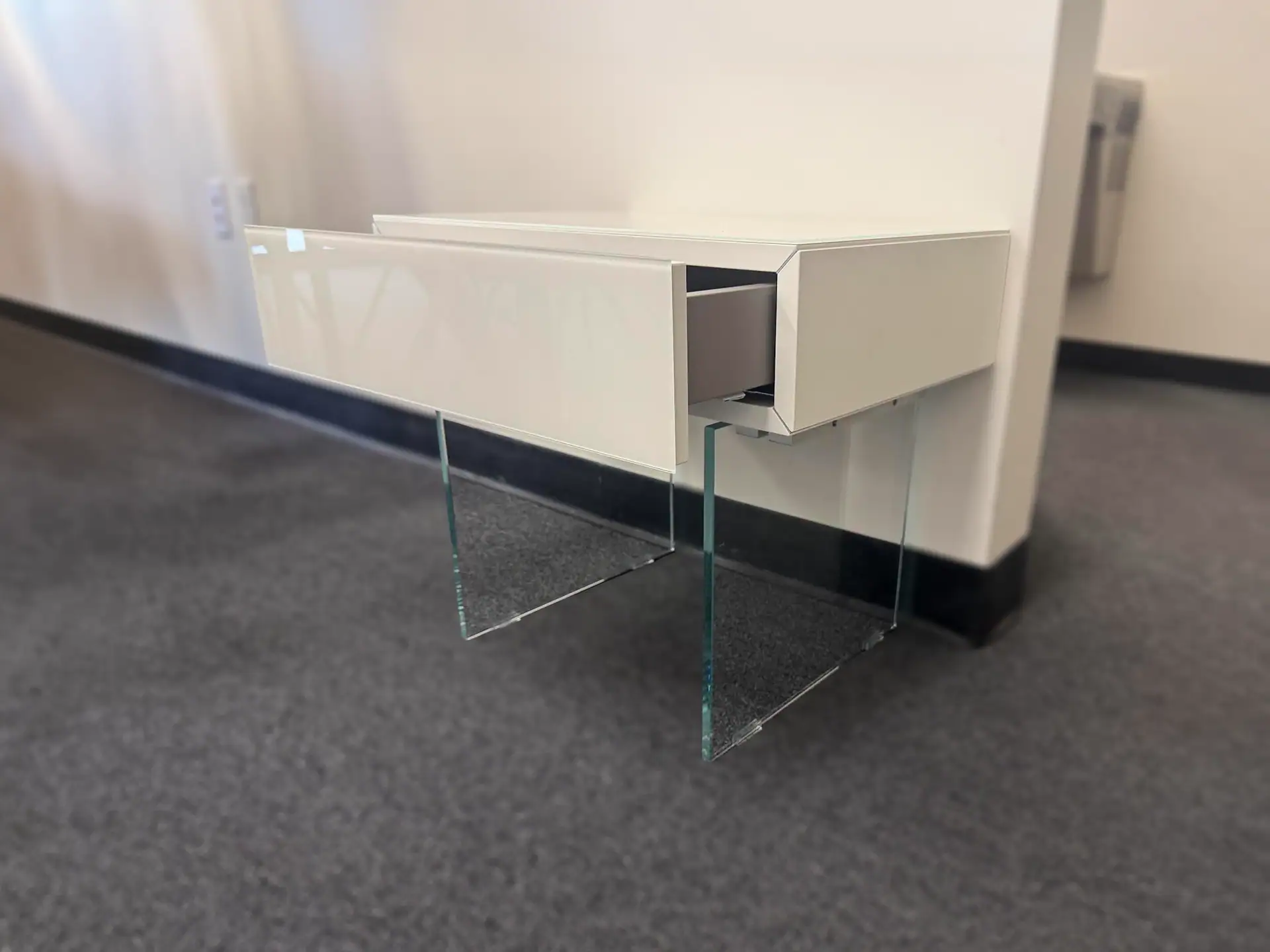 Lago 36e8 1-Drawer Nightstand with glass legs in a modern room.