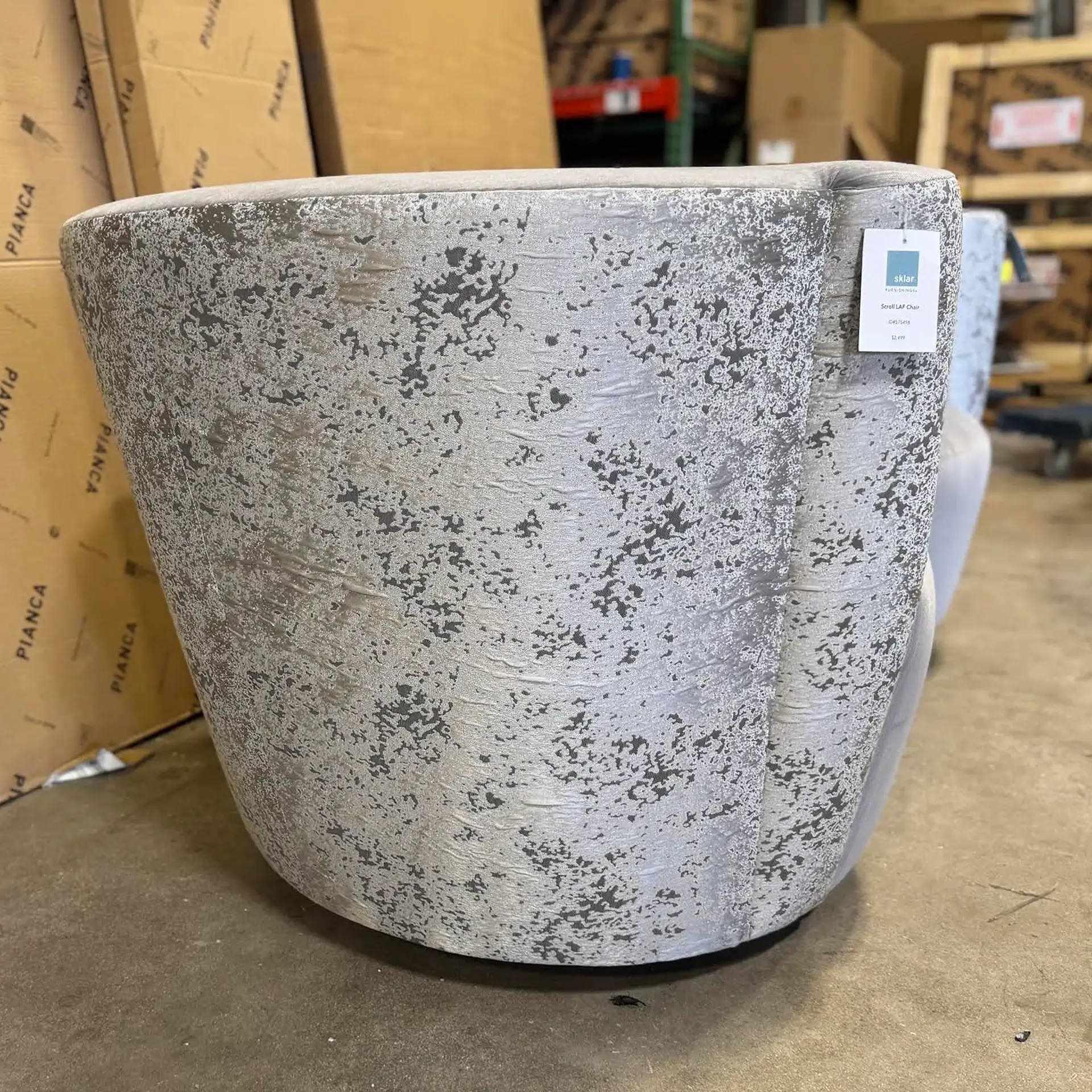 Large concrete planter with a textured surface in a warehouse setting.