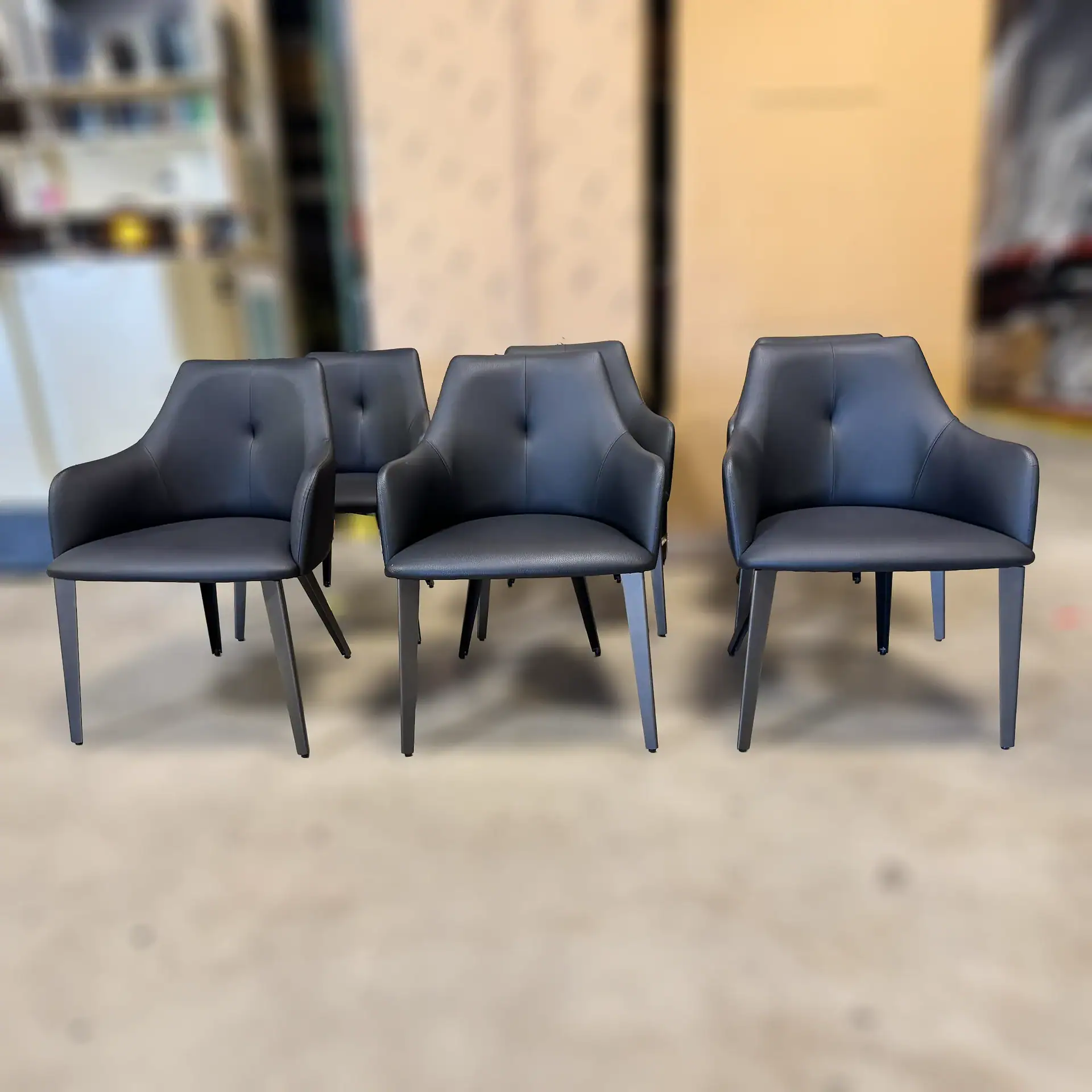 Sklar Furnishings Nuevo Renee dining chairs in black with armrests.