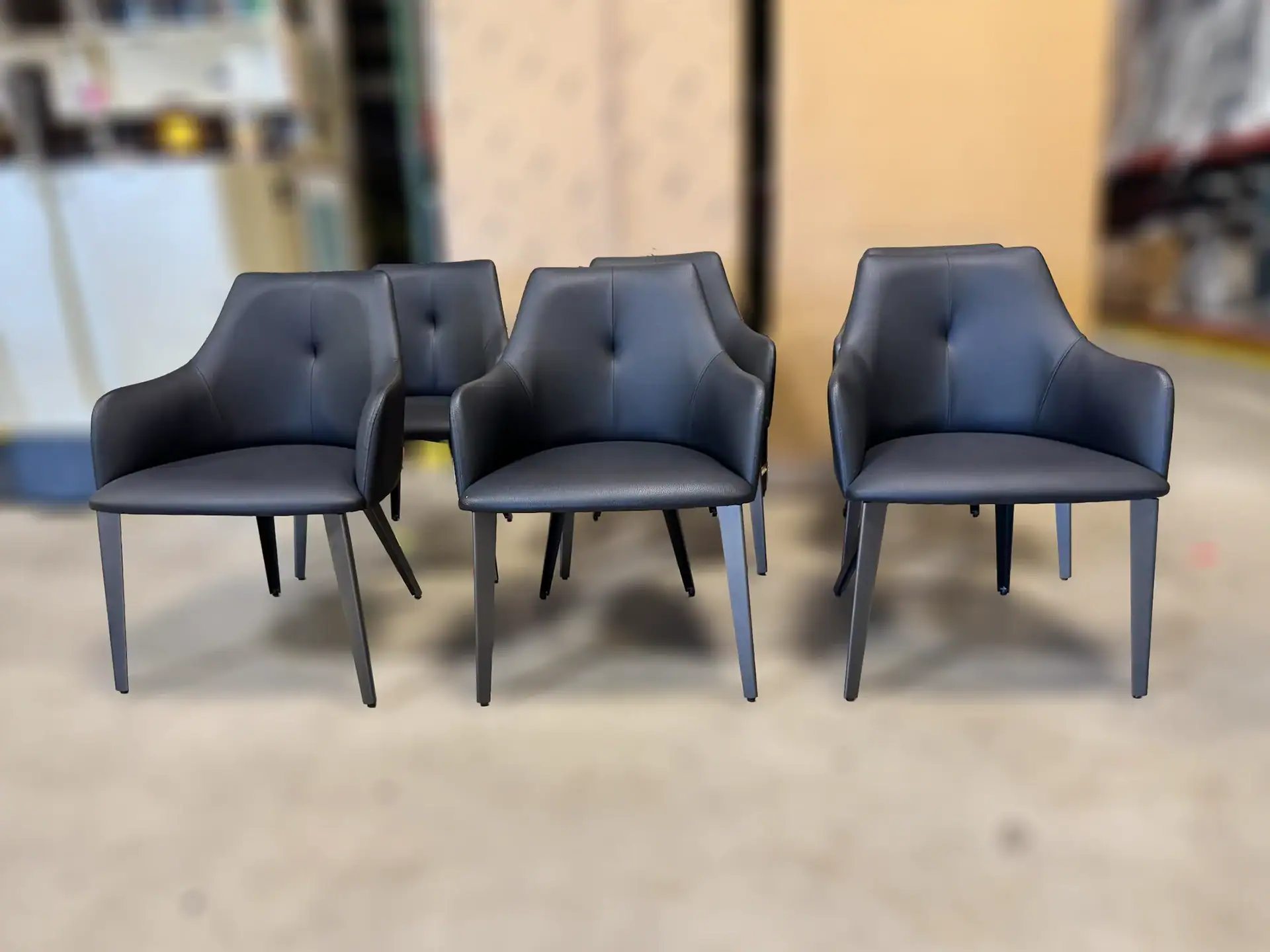 Sklar Furnishings Nuevo Renee dining chairs in black with armrests.