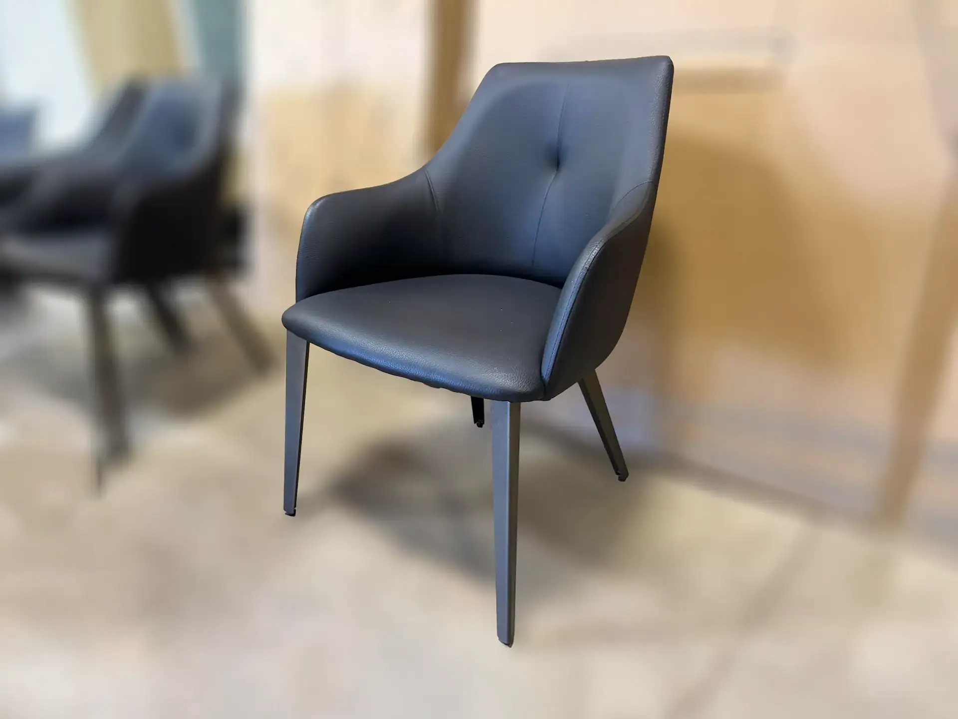 Sklar Furnishings Renee dining chair in black with wooden legs.