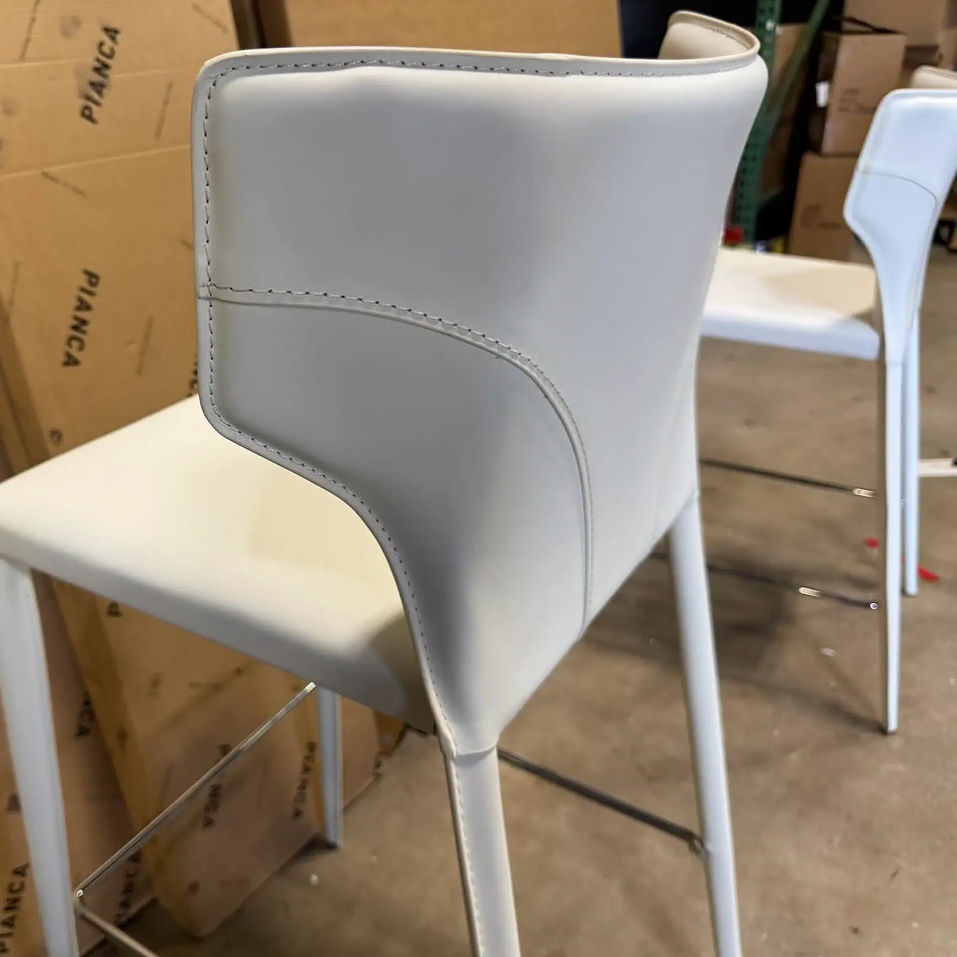 Sklar Furnishings Nuevo Wayne bar stool with white upholstery and modern design.