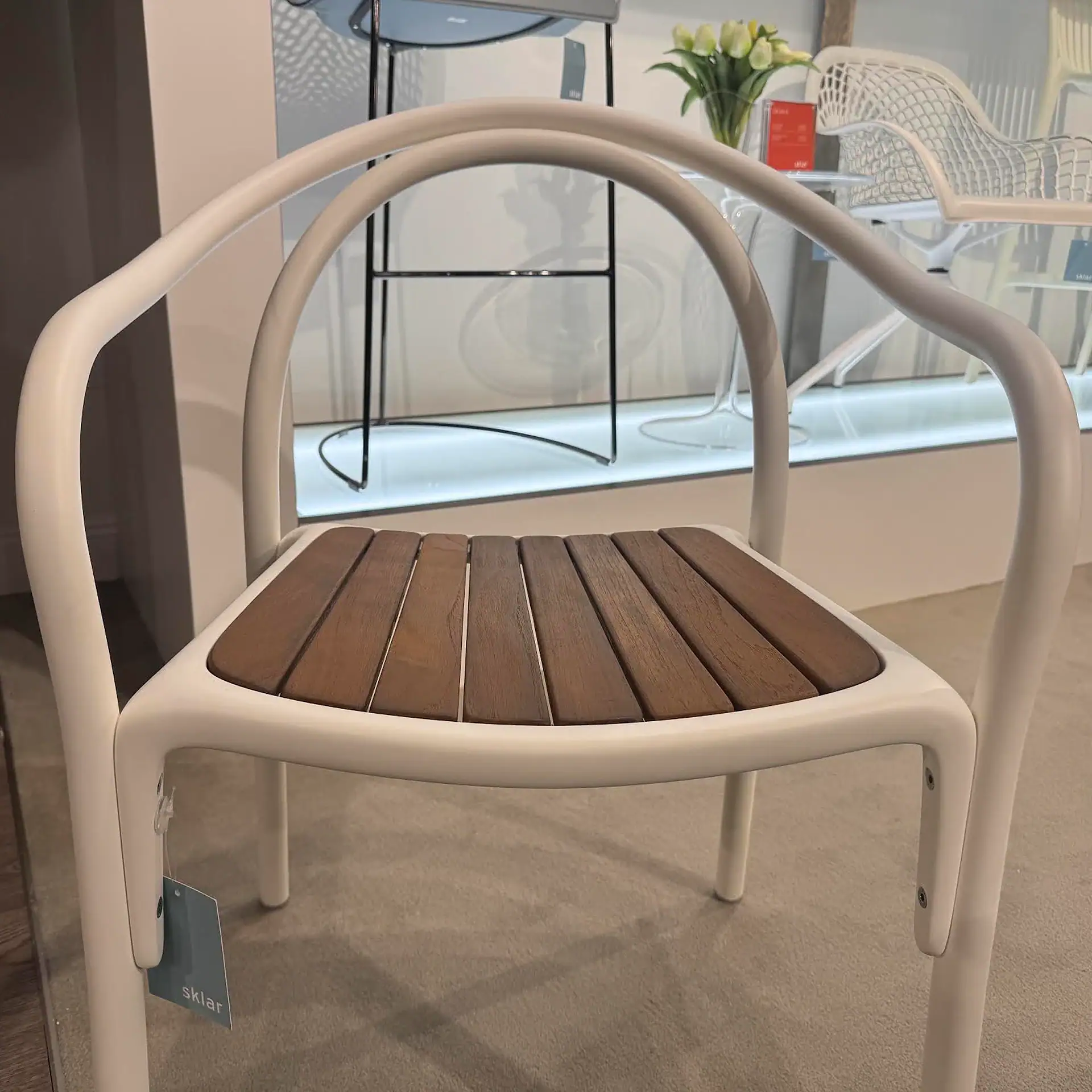 Sklar Furnishings Soul Armchair with wooden seat and white frame.