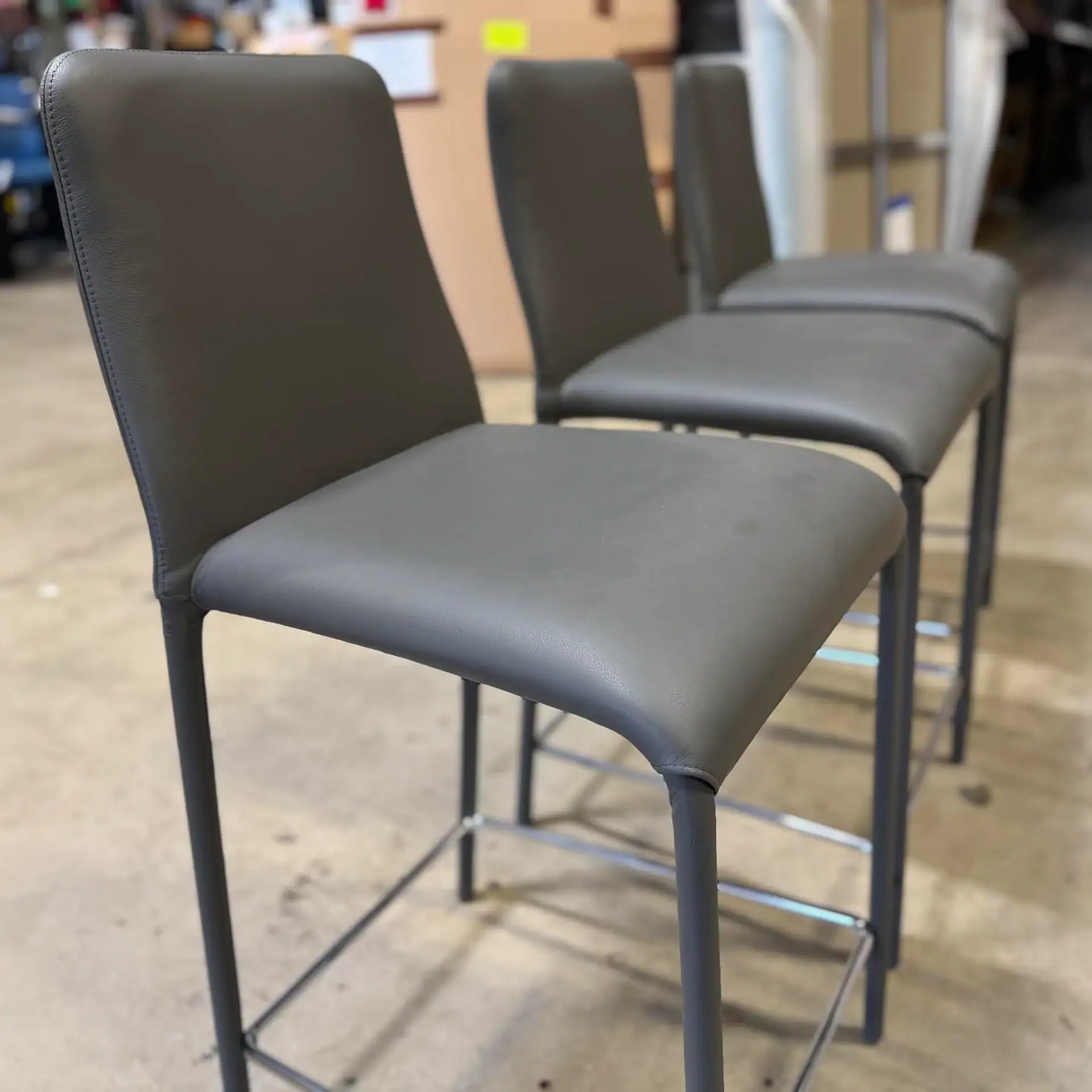 Sklar Furnishings Peressini Casa Swing counter stools in a row.