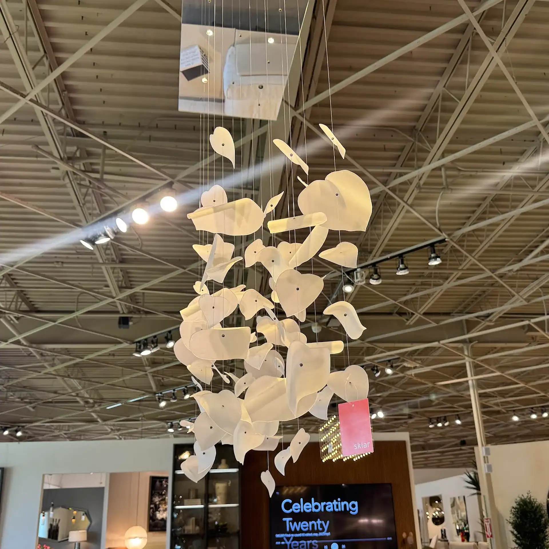 Reflex Leaf chandelier with leaf-shaped LED lights hanging from ceiling.