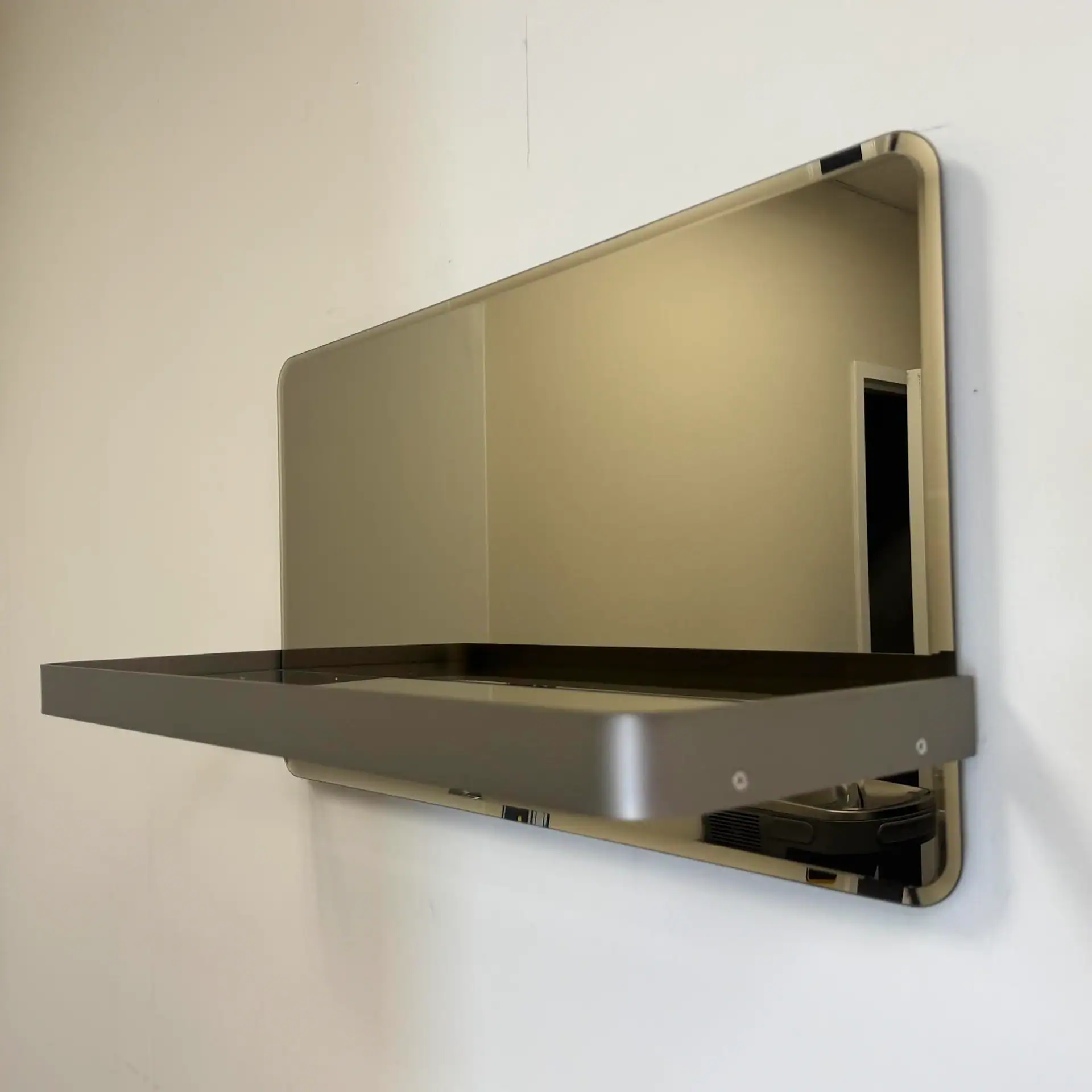 Reflex Shelf Mirror by Sklar Furnishings in a room.