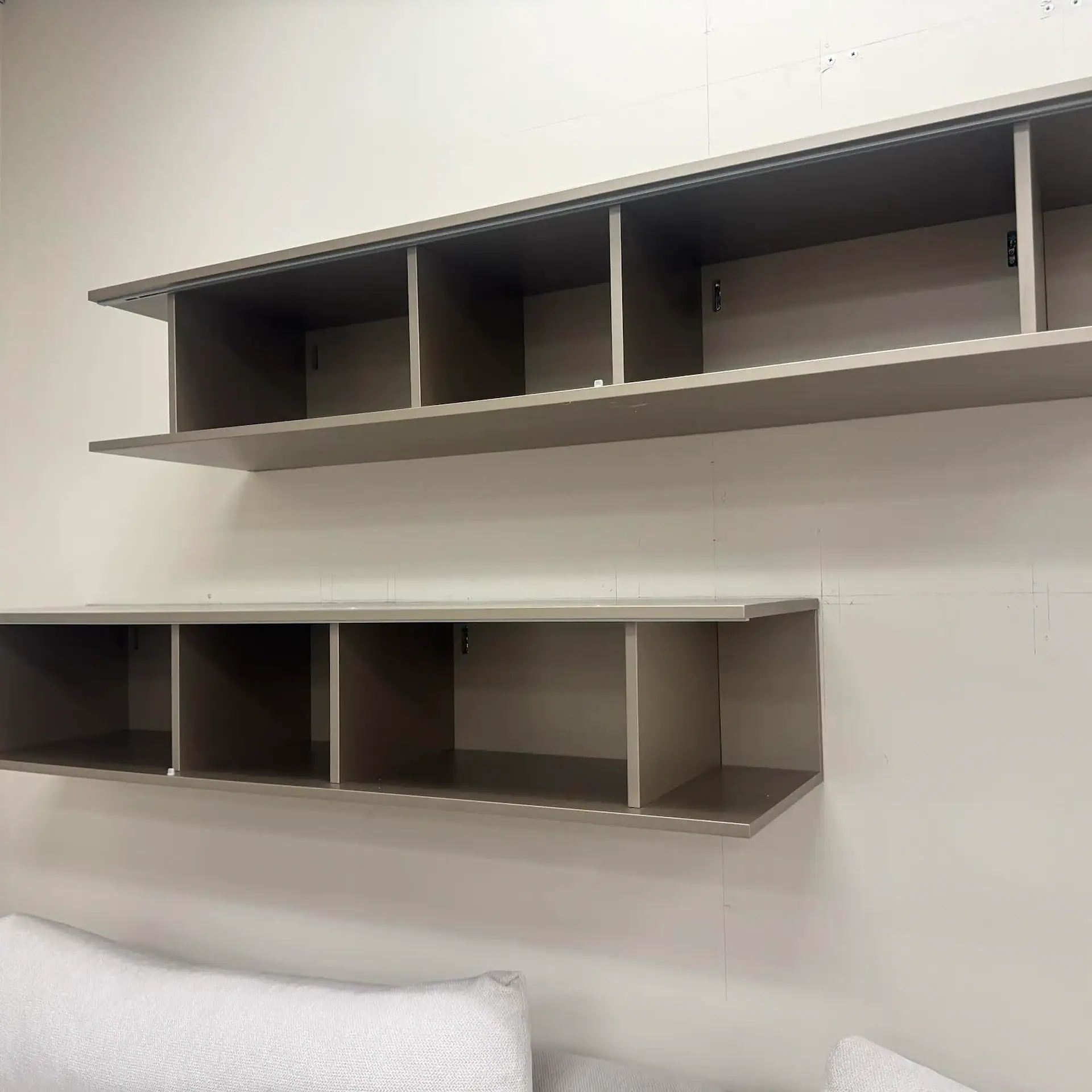 San Giacomo Alias hanging bookcase with open shelves in a room setting.