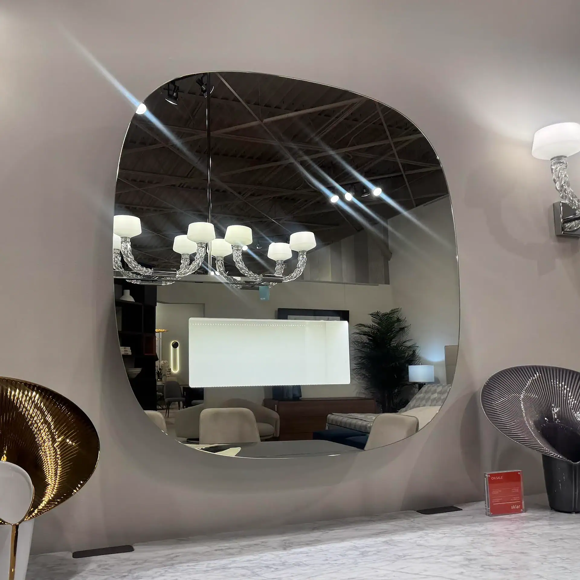 Tonelli Aperture LED Mirror with modern chandelier reflection.