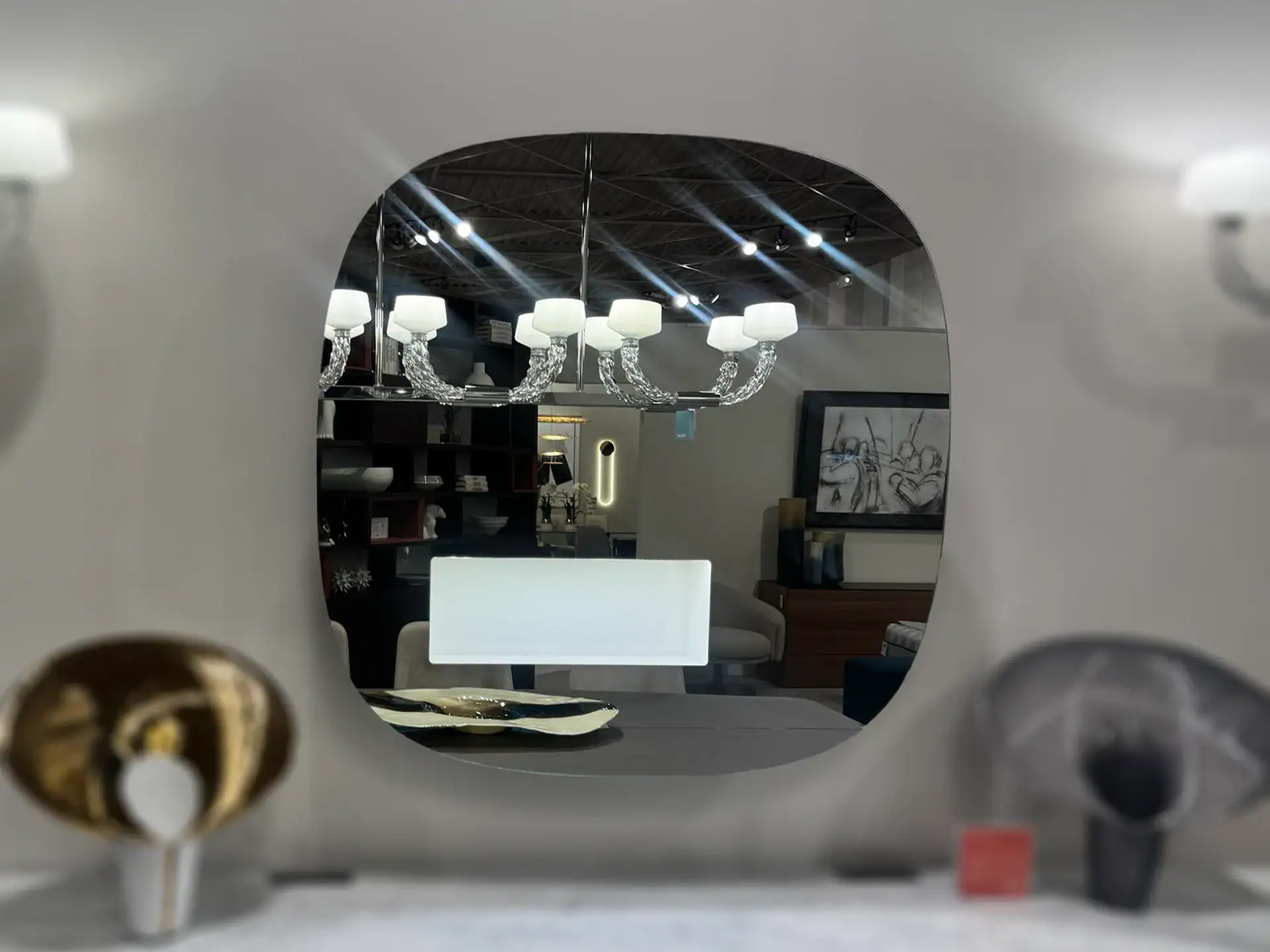 Tonelli Aperture LED Mirror reflecting a modern living room.