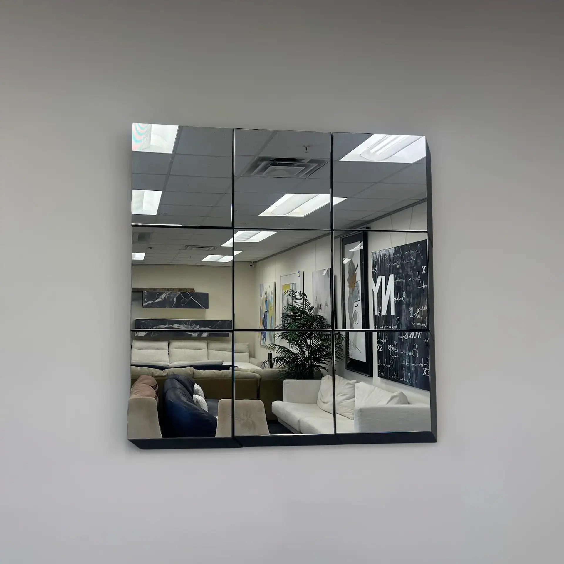 Tonelli Guidoriccio modular mirror tile reflecting office interior.
