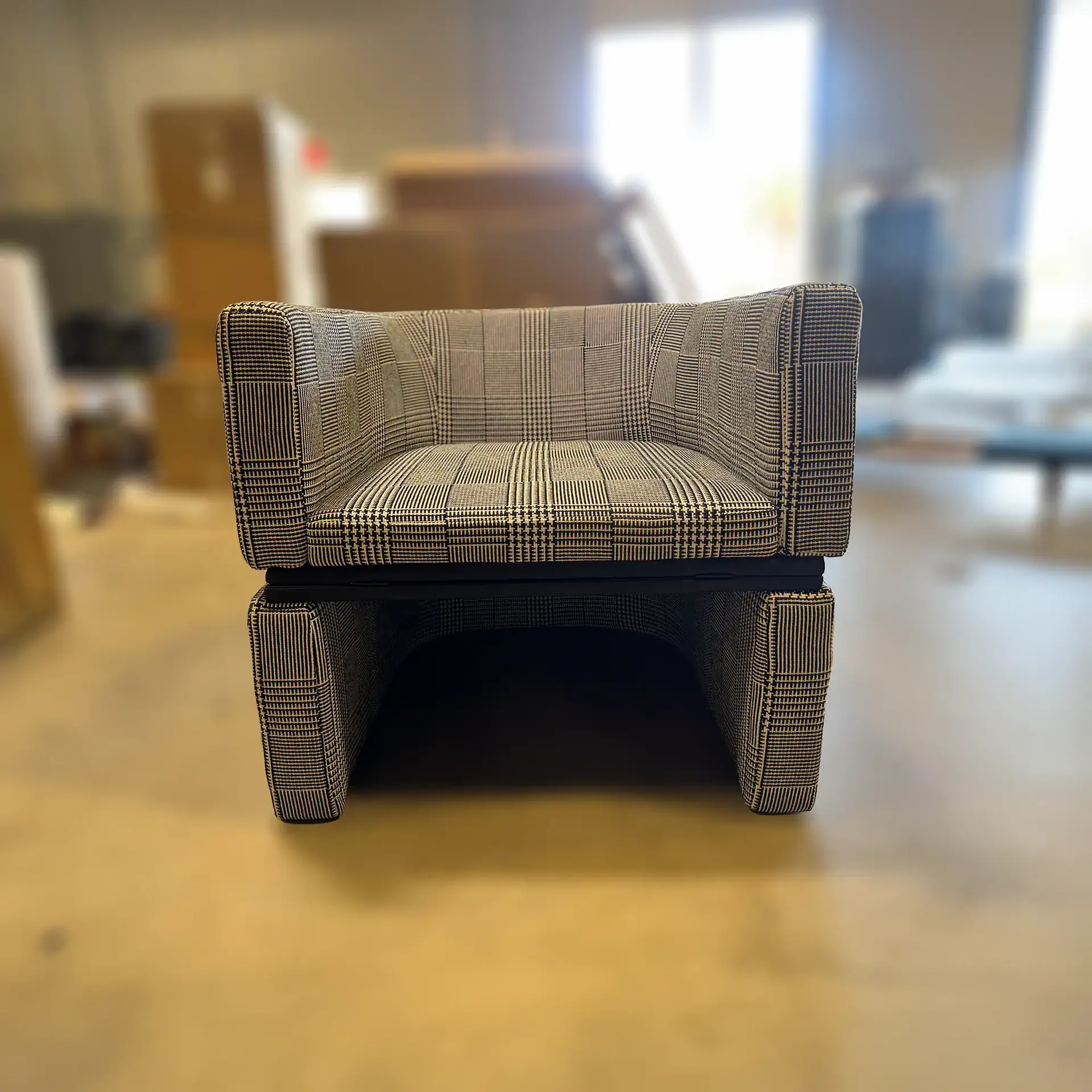 Sklar Furnishings Flip Open Armchair with plaid fabric in a room setting.