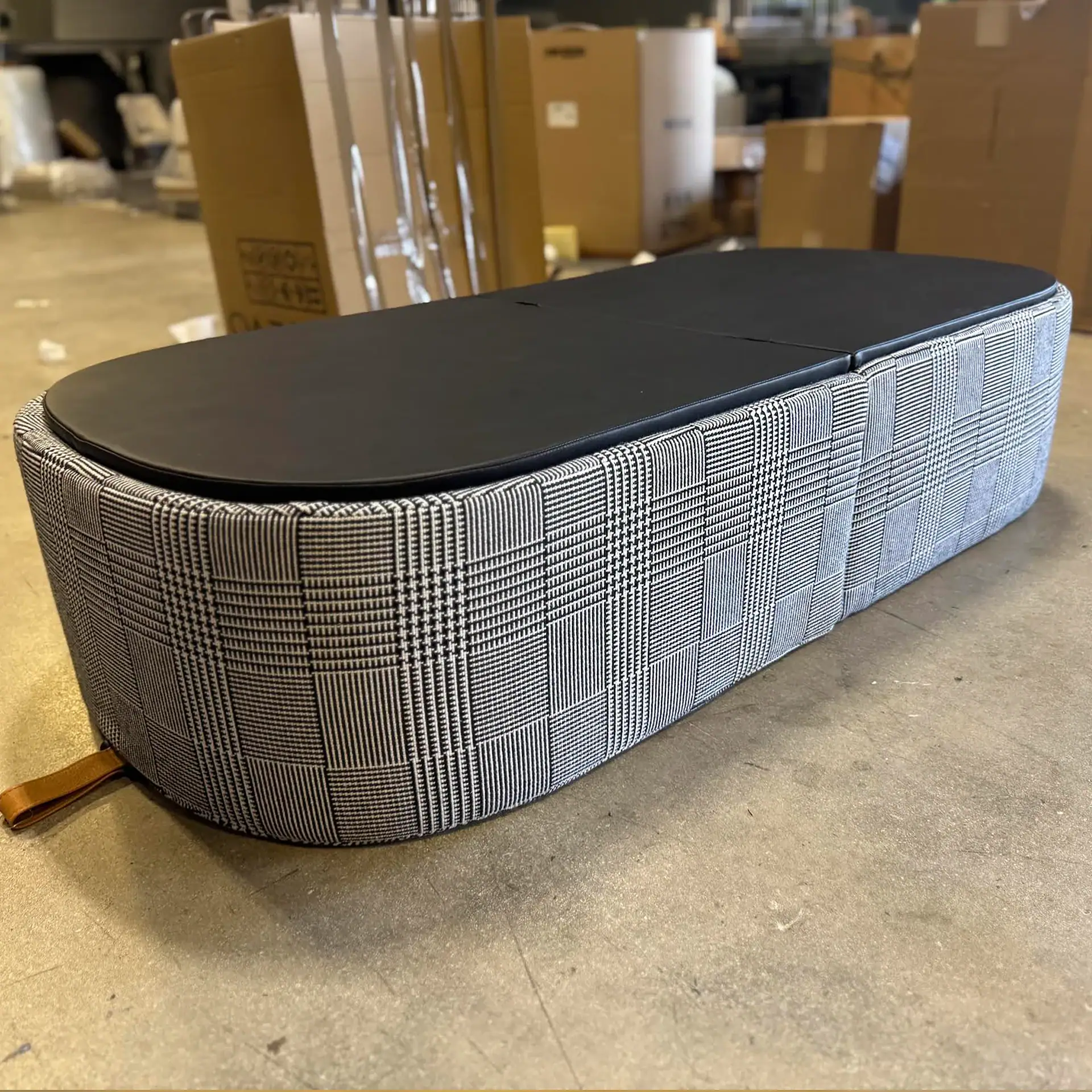 Tumidei Flip Open Armchair with plaid fabric and black top in warehouse.
