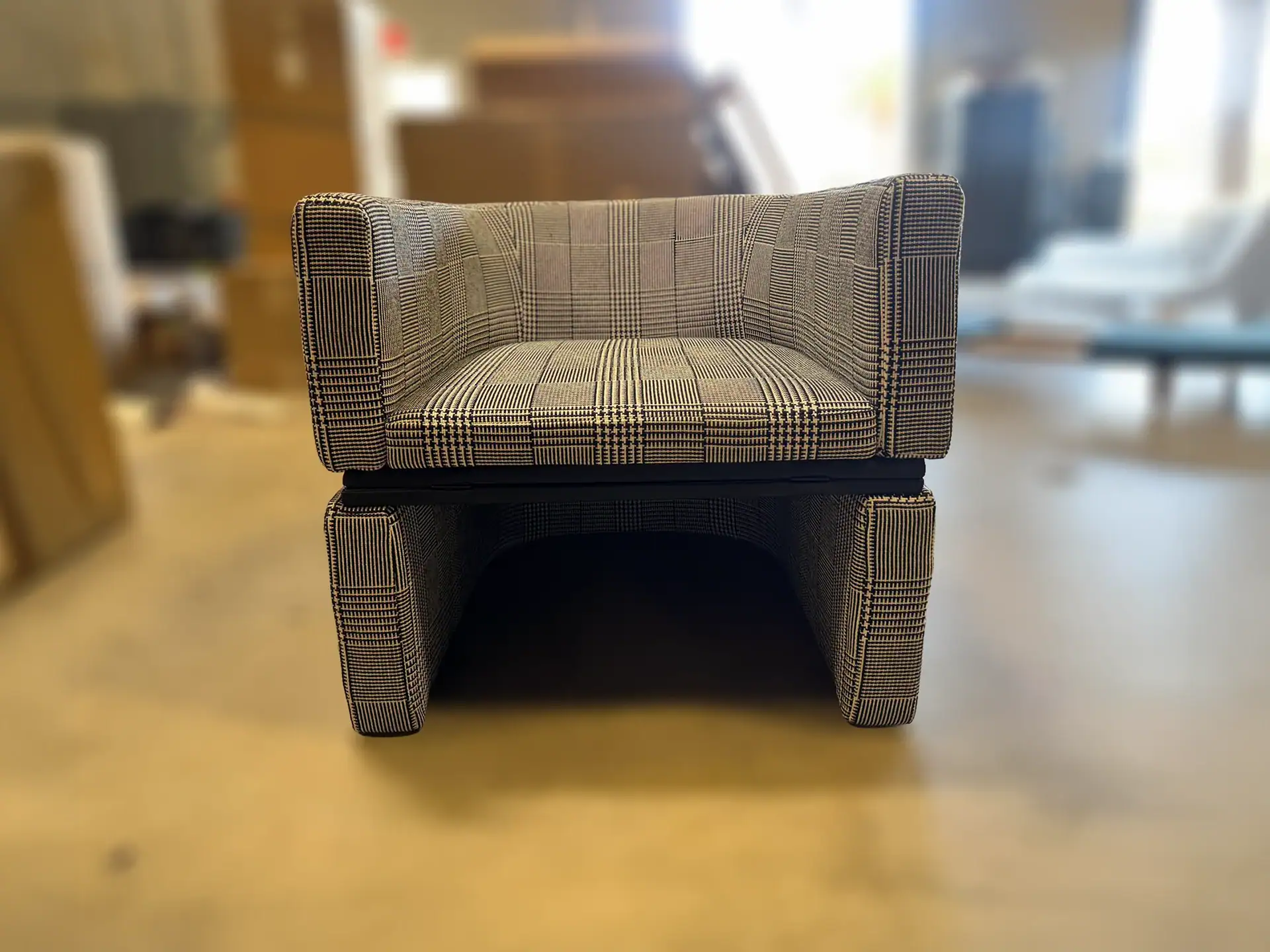Tumidei Flip Open Armchair with plaid fabric in a room setting.