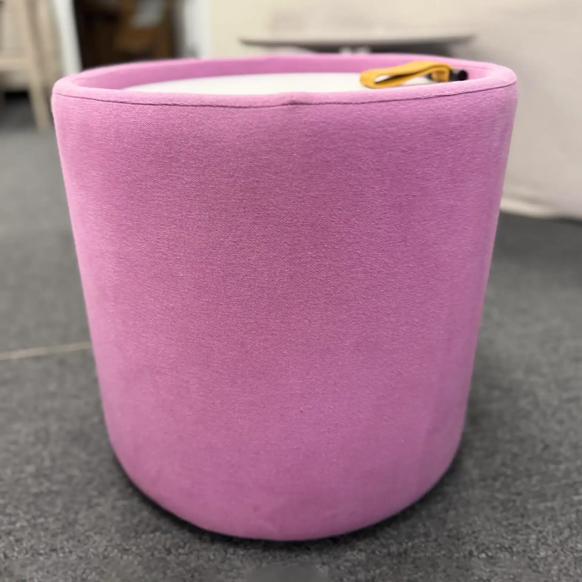 Pink Pill Top Pouf Table with yellow zipper detail.