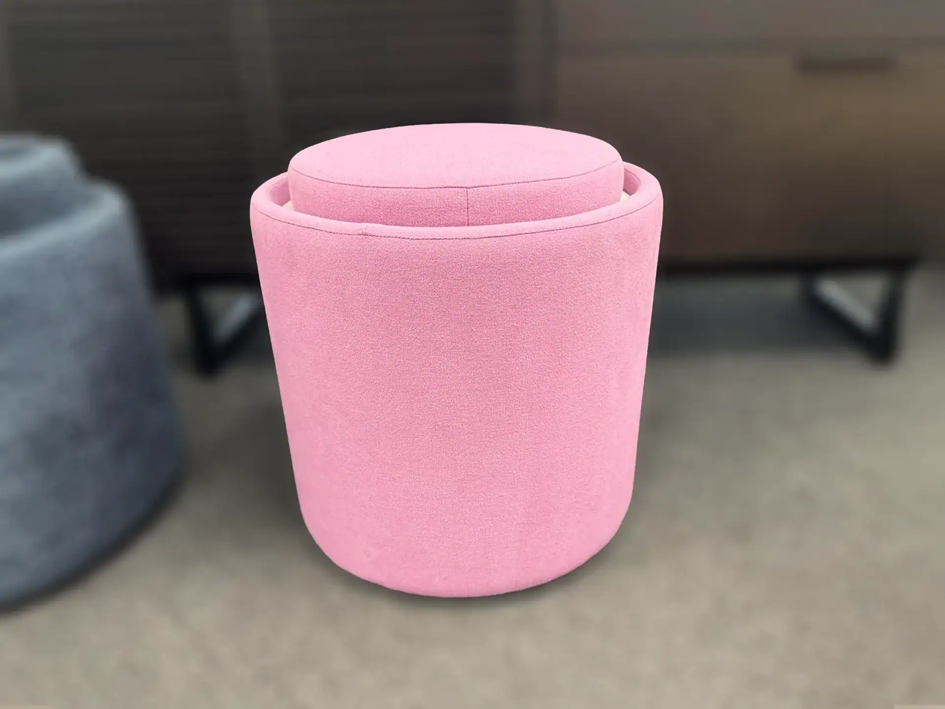 Pink Pill Top Pouf Table with a soft fabric finish in a room setting.