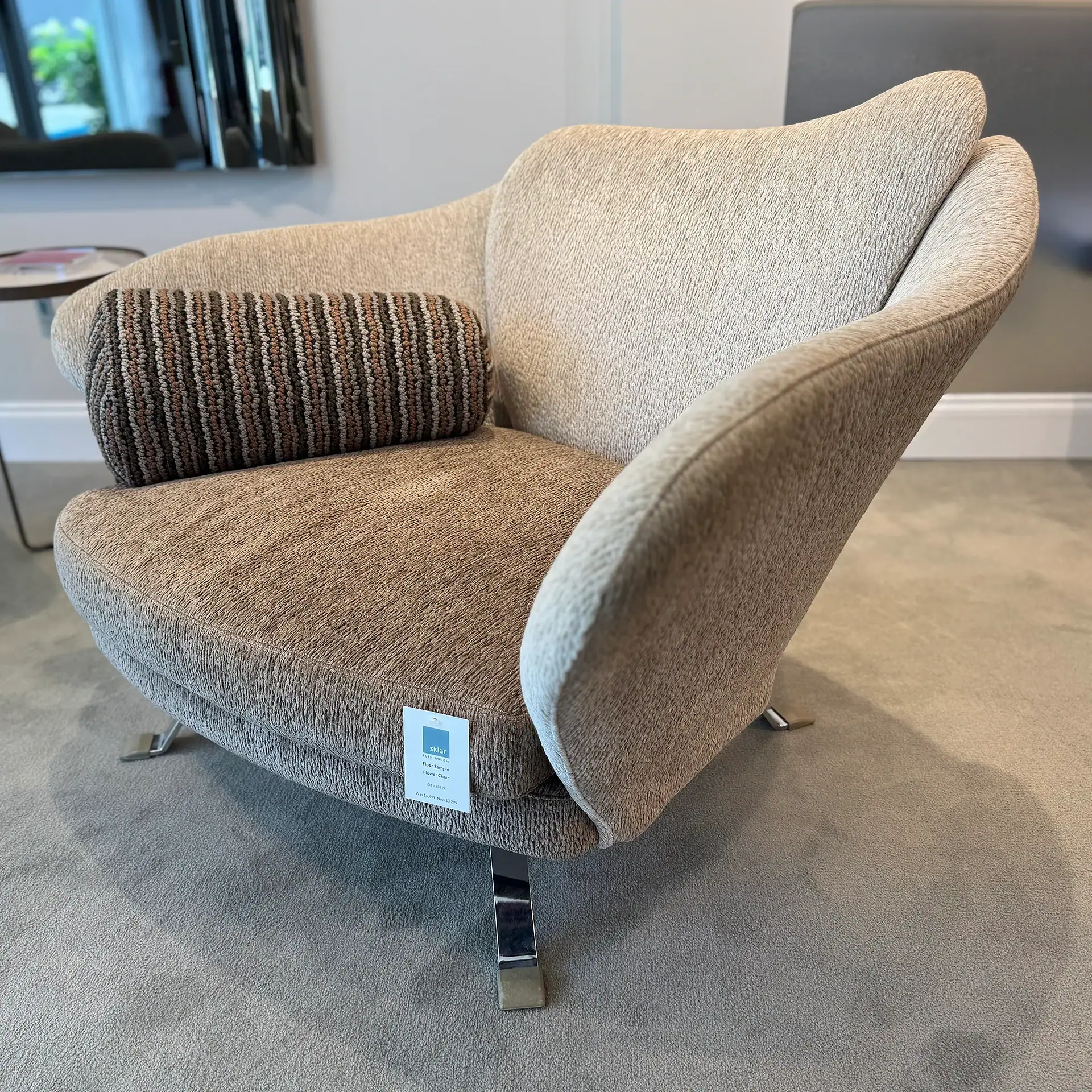 Sklar Furnishings flower armchair with a striped cushion in a room setting.