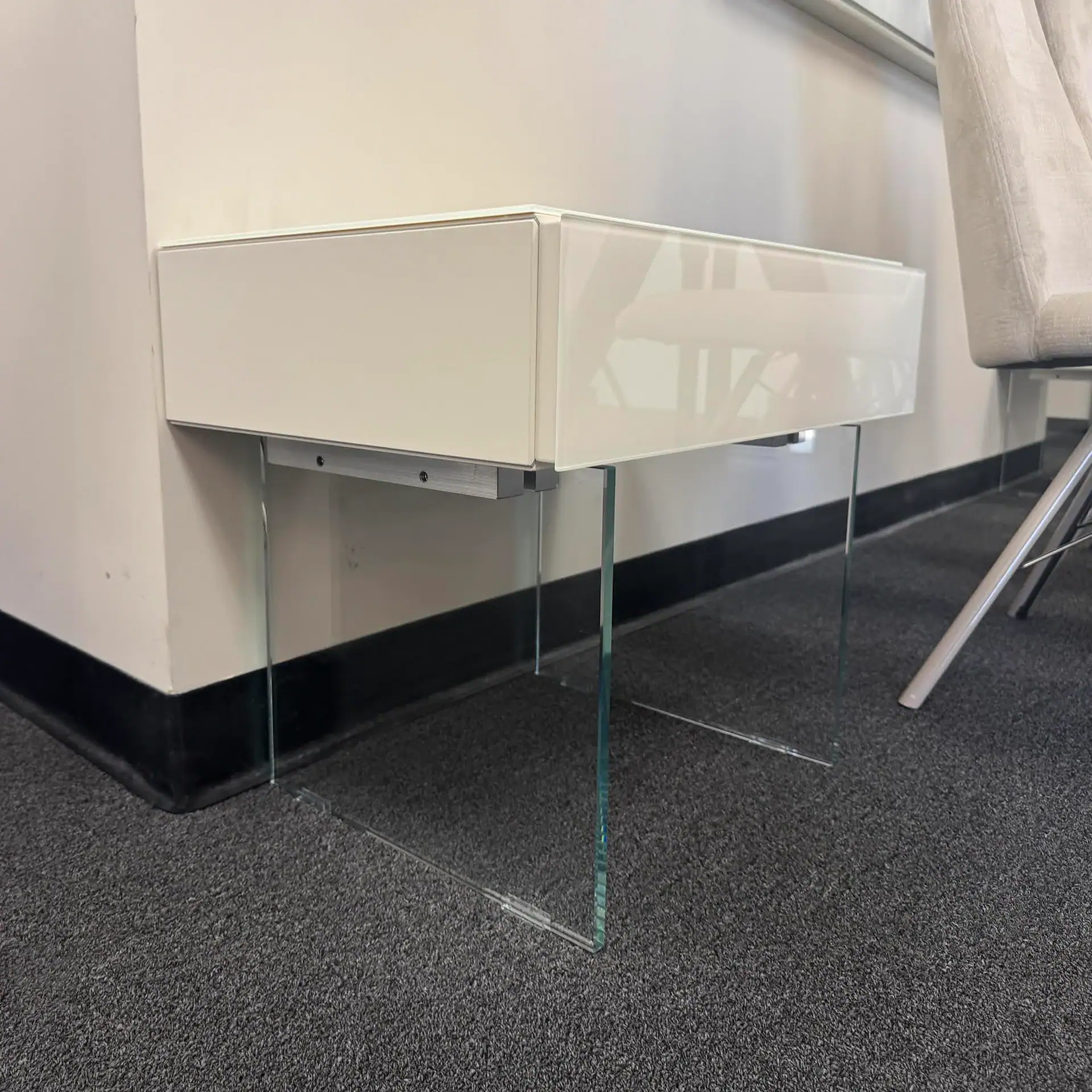 Lago 36e8 1-Drawer Nightstand with glass legs in a modern room.
