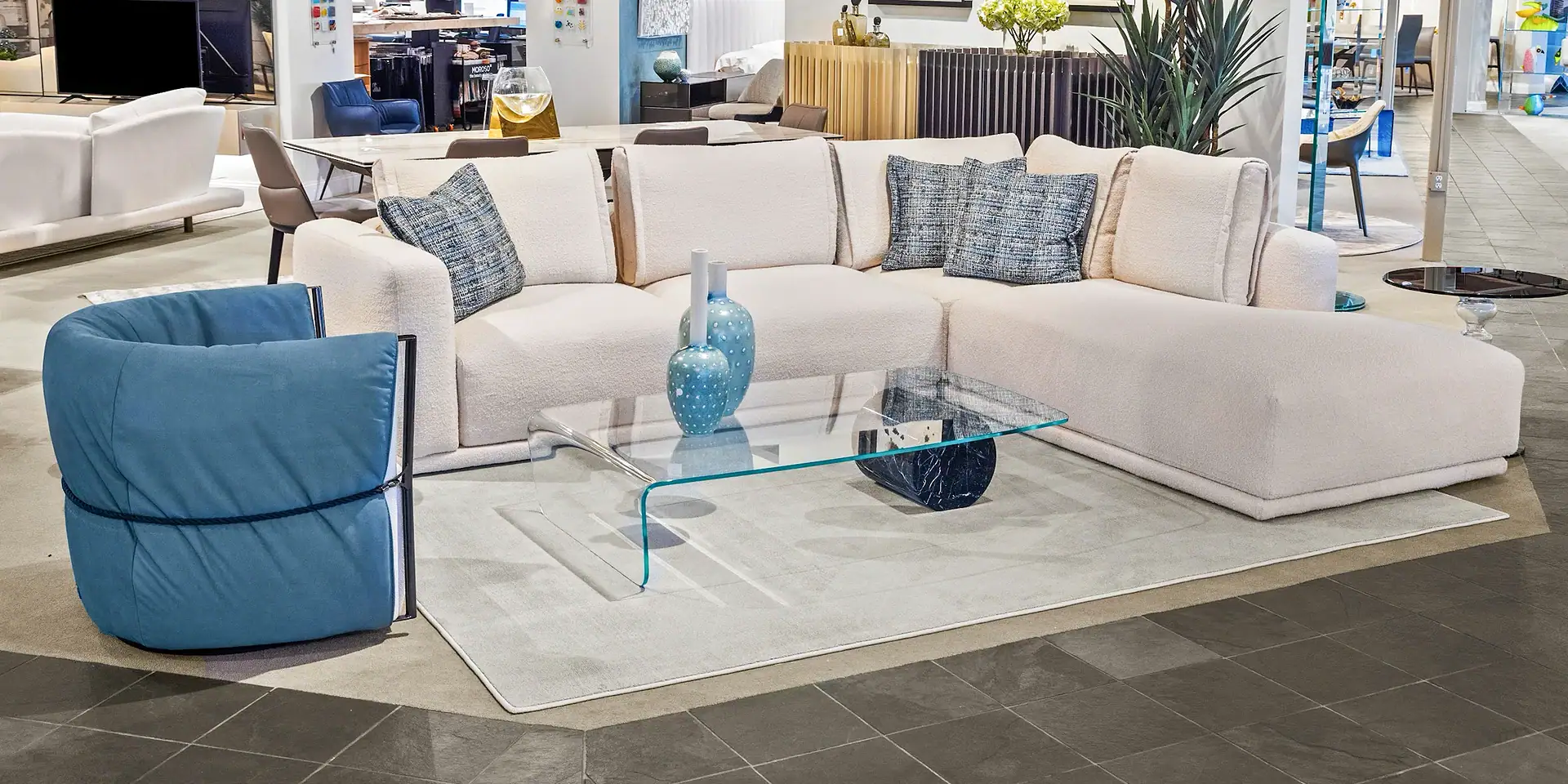 Contemporary sectional sofa with blue accent chair in a modern living room setting.