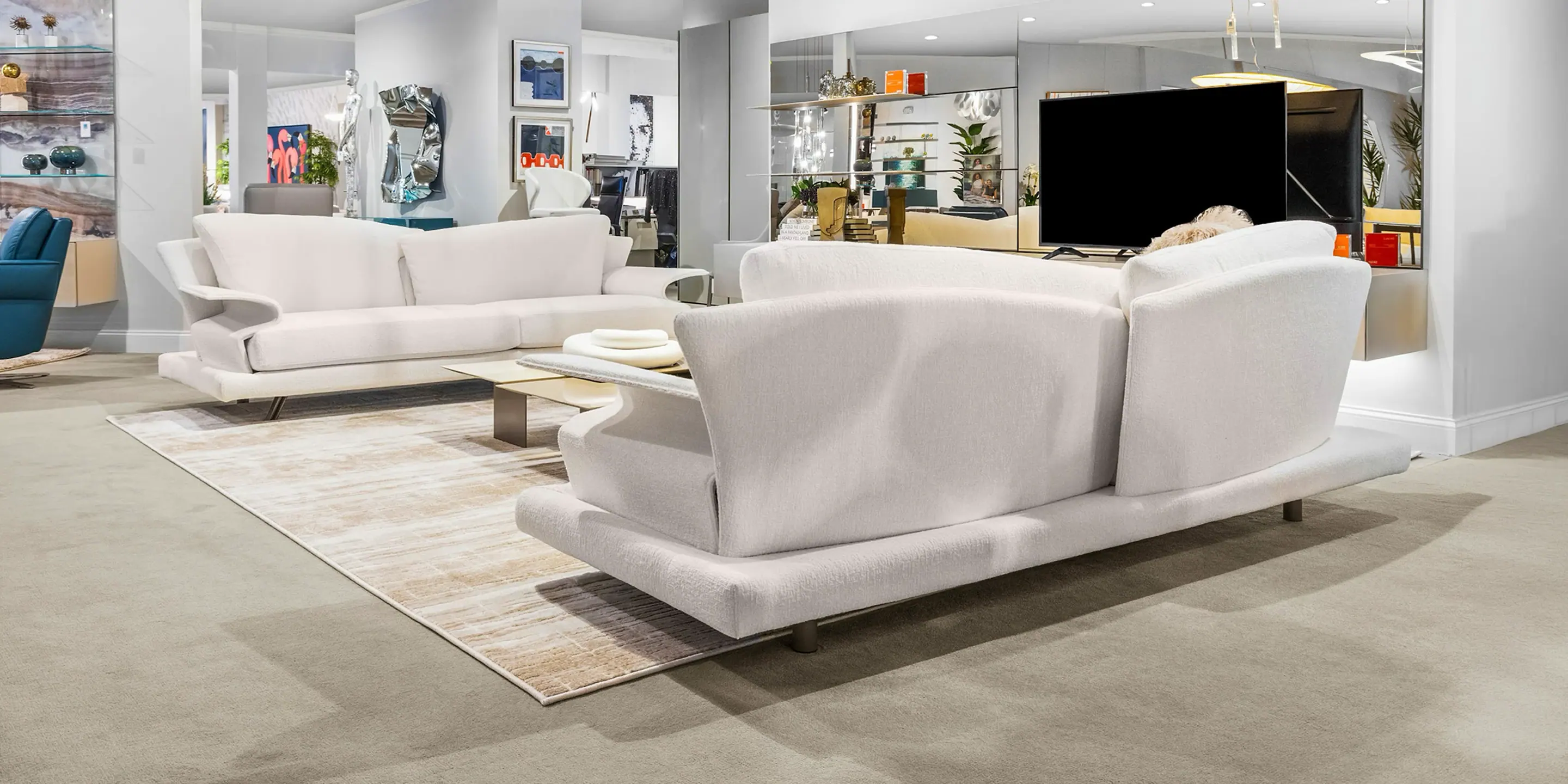 showroom-vignette-jun-26-living-room Modern white sofa set in a spacious living room with contemporary decor.
