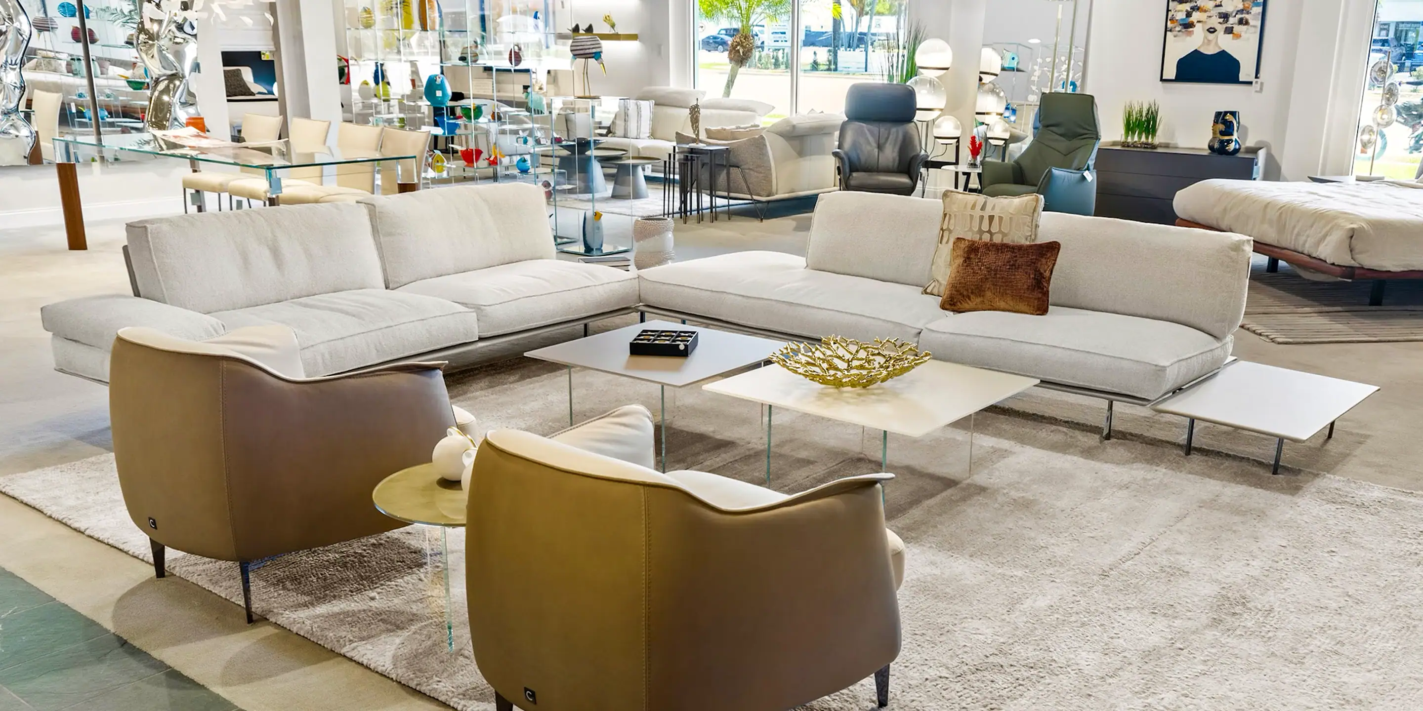 Modern White Sectional Sofa Modern white sectional sofa with brown accent pillows in a bright showroom.