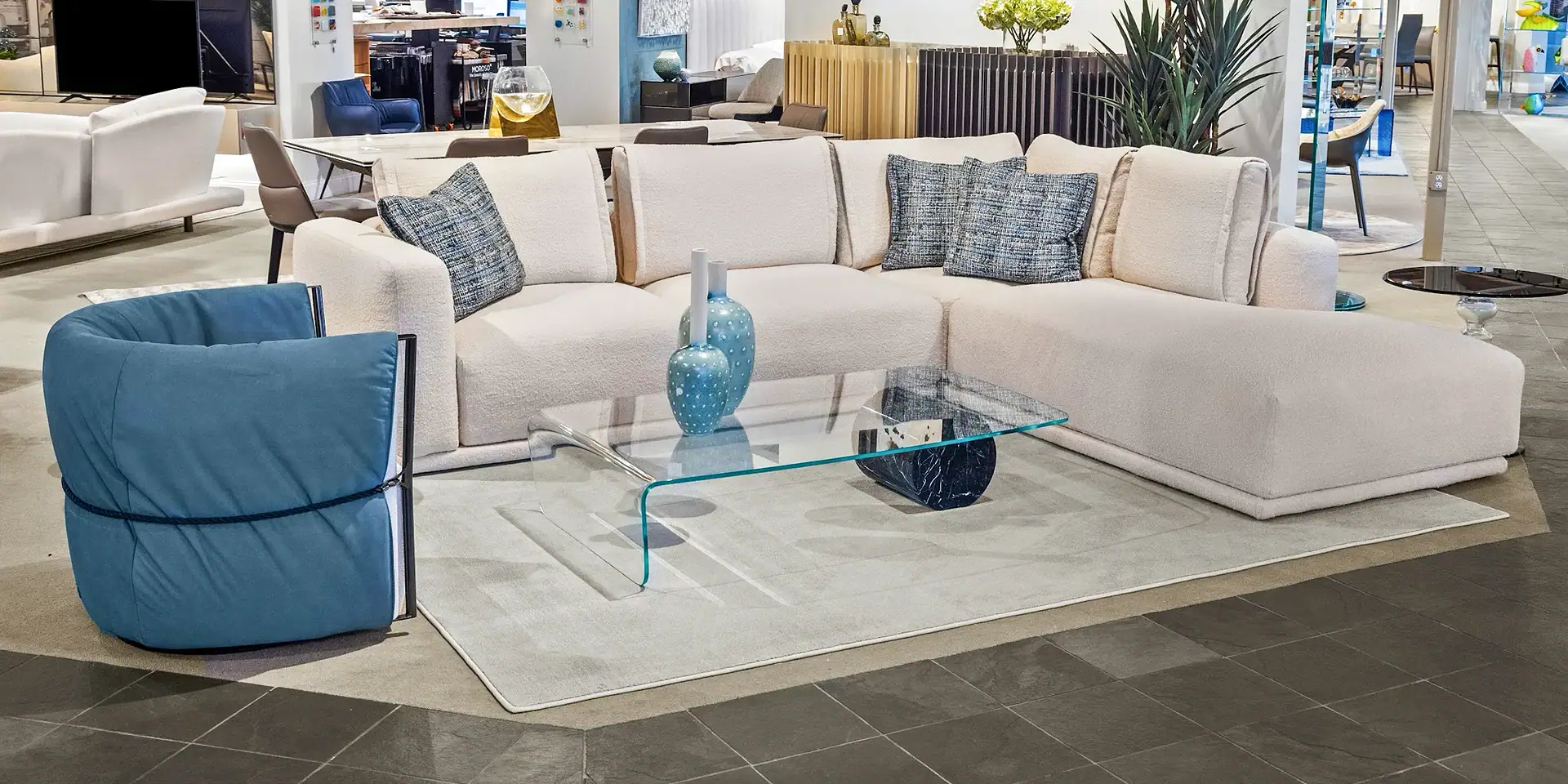 Contemporary sectional sofa with blue accent chair in a modern living room setting.