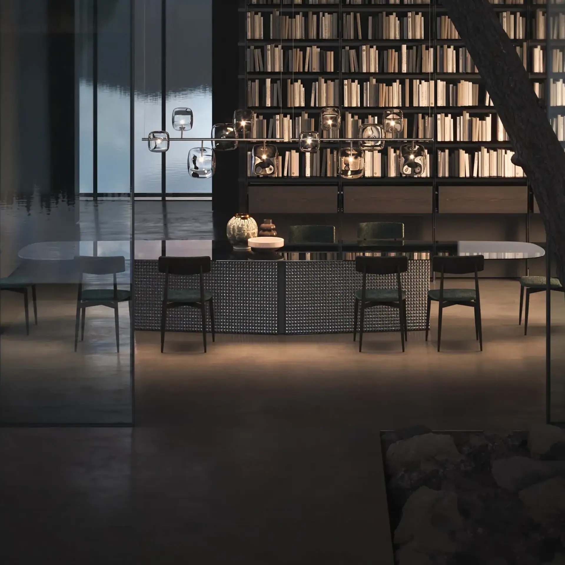 Contemporary dining space with a large bookshelf and stylish lighting fixtures.