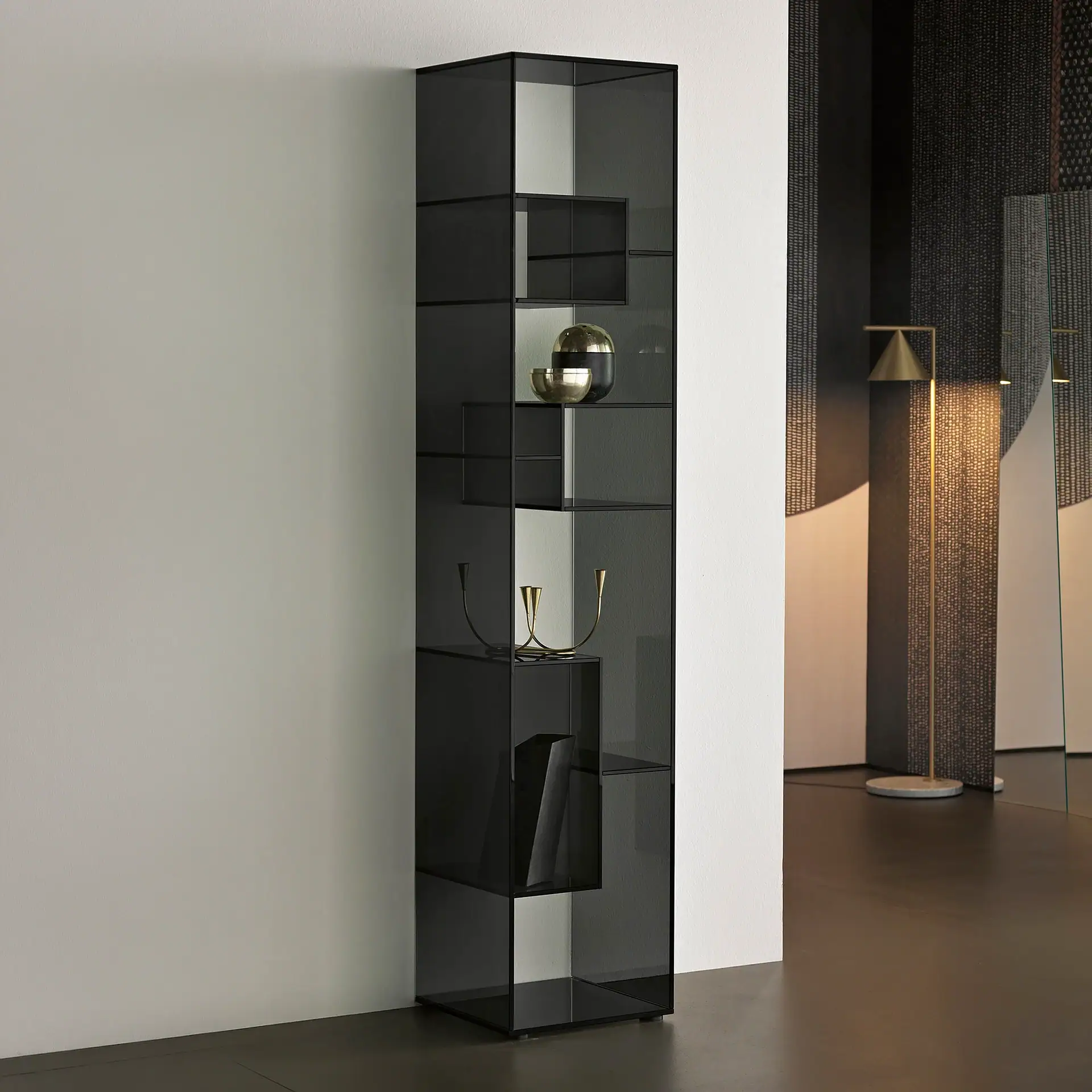 Sklar Furnishings display cabinet with glass shelves and decorative items.