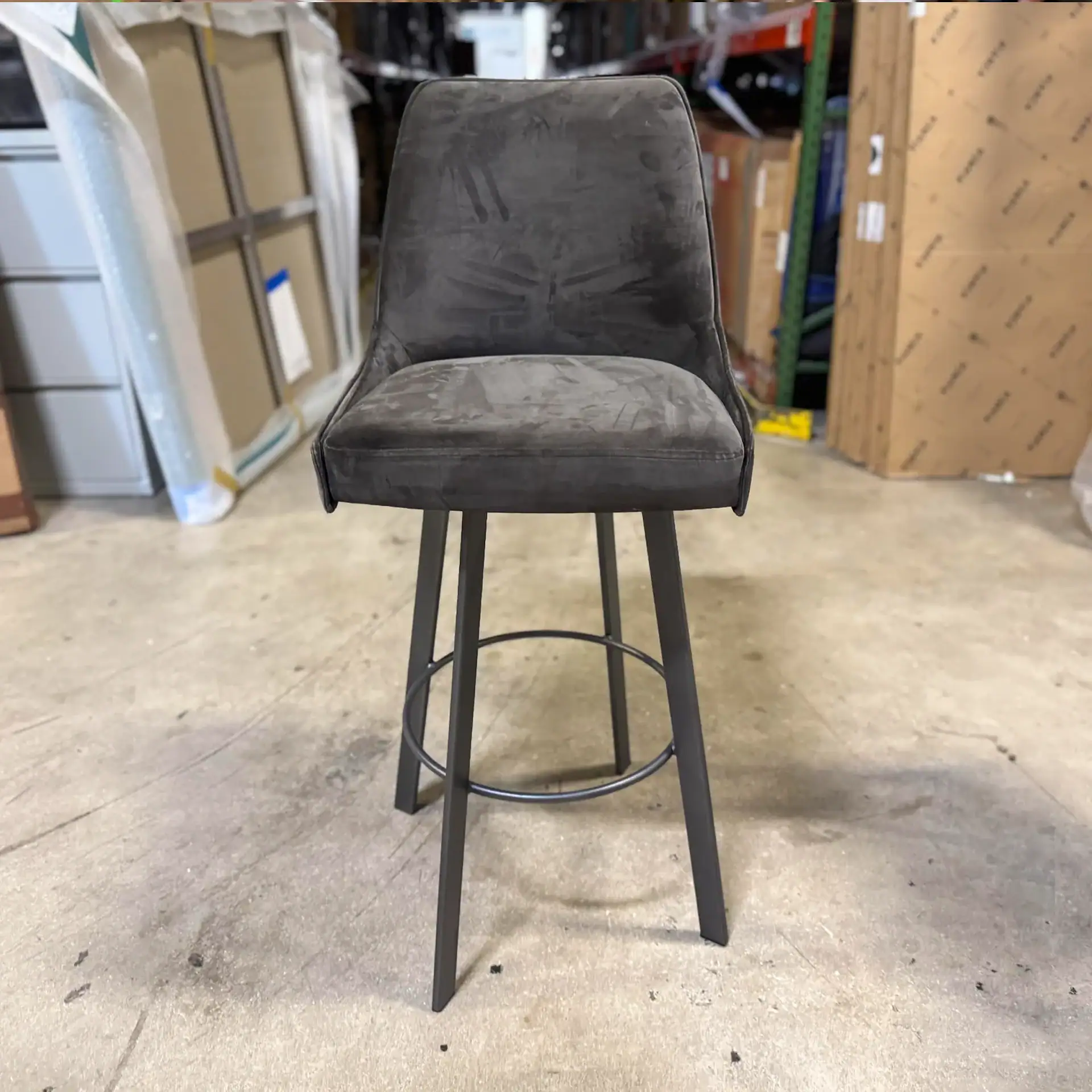 Trica Sofia & Olivia bar stool with dark grey upholstery and black metal legs.