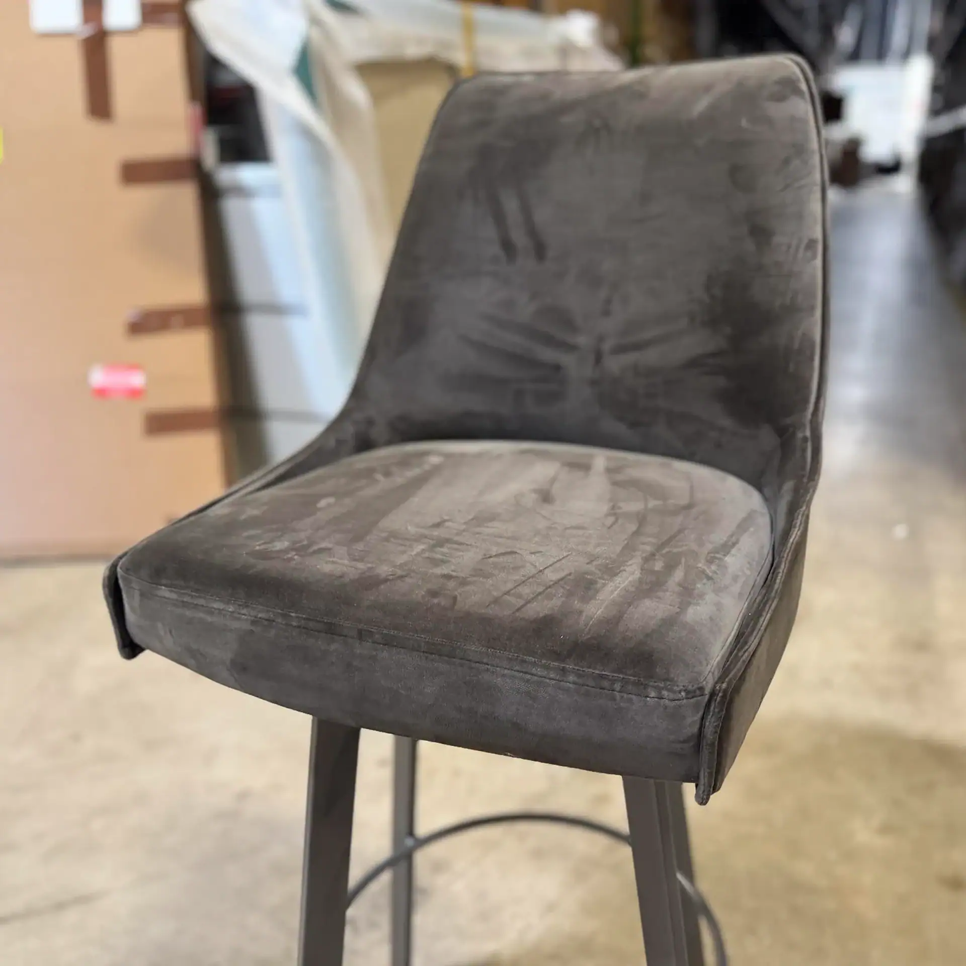 Sklar Furnishings bar stool with gray velvet upholstery and black metal legs.