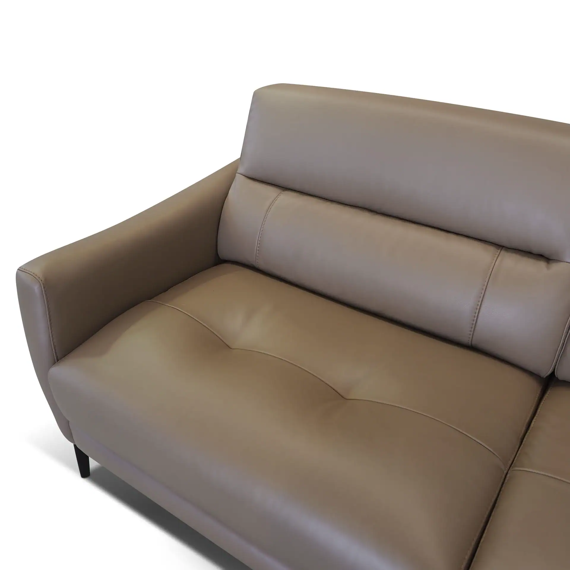 Close-up of a light brown leather sofa with a rounded armrest and tufted seat, on a white background.
