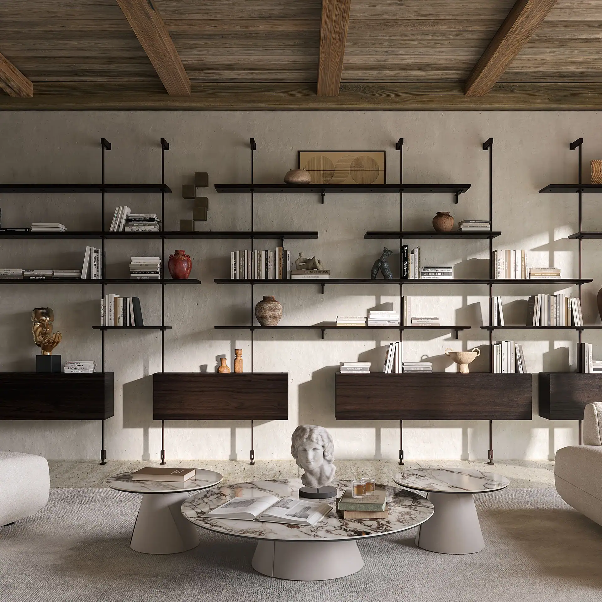 A modern living room with a large dark wood and metal shelving unit against a light wall, filled with books and decorative objects. Three round marble coffee tables are in the foreground on a light rug.