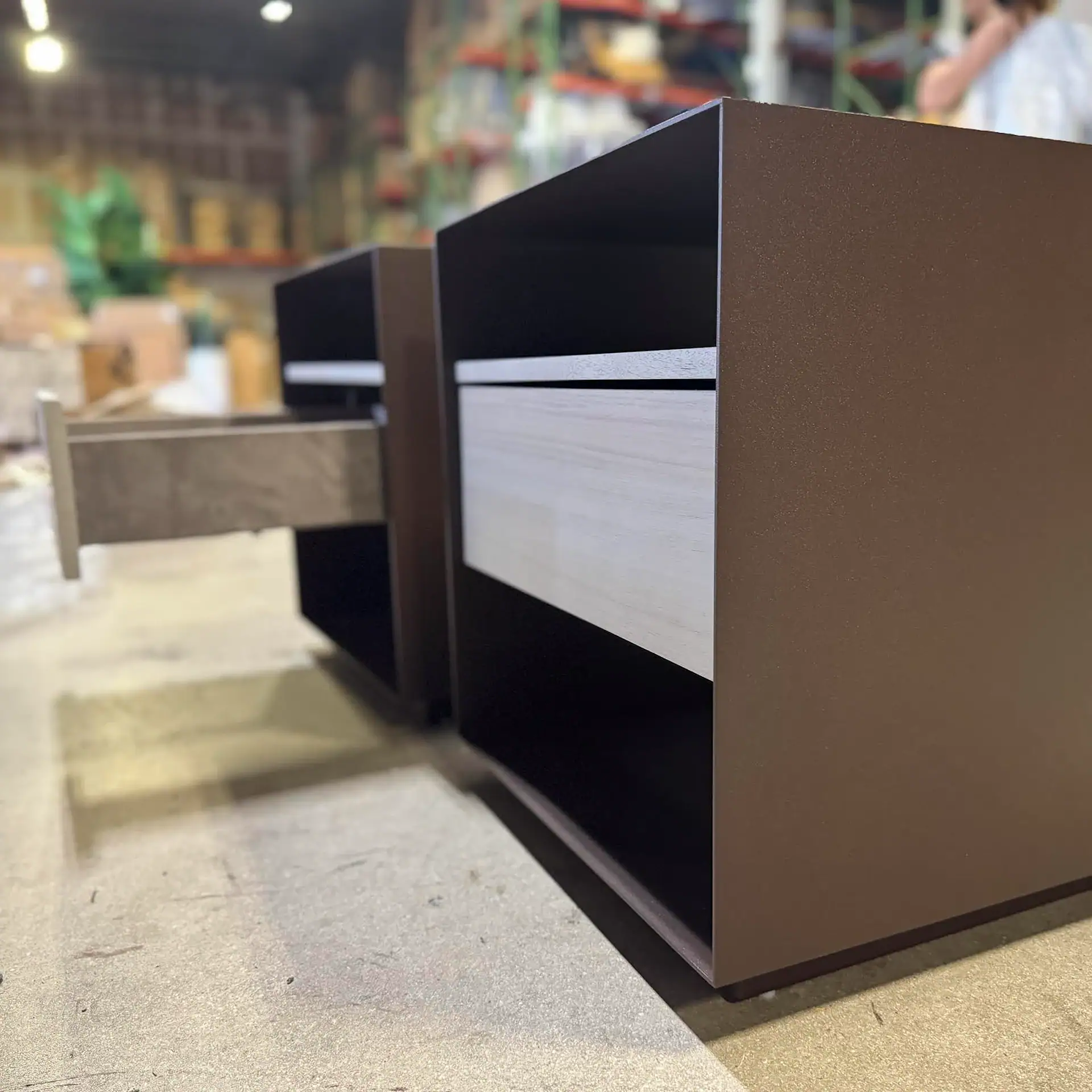 Trica Boulevard 1 Drawer Nightstand in a furniture store.
