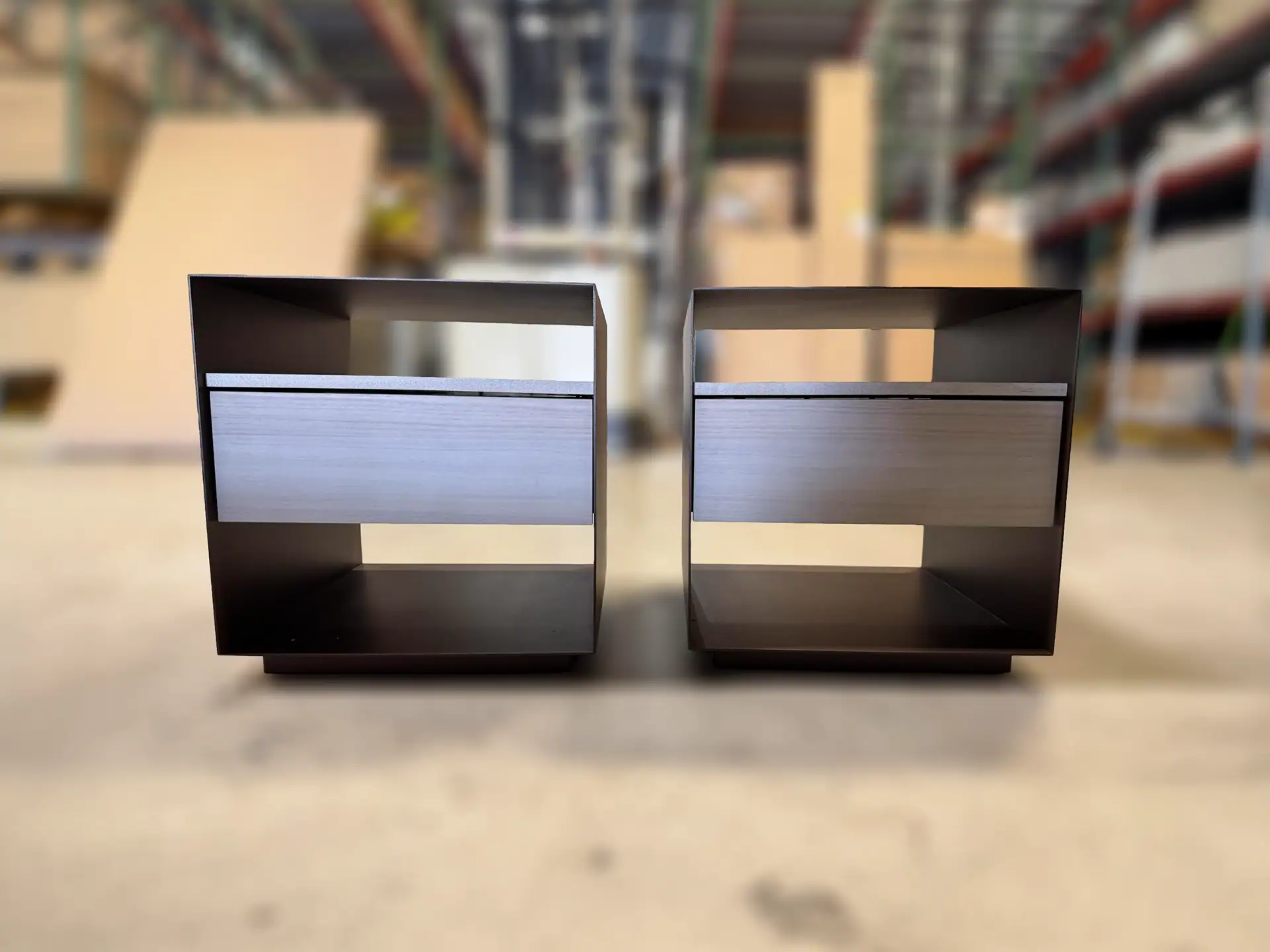 Trica Boulevard 1 Drawer Nightstand pair in a store setting.