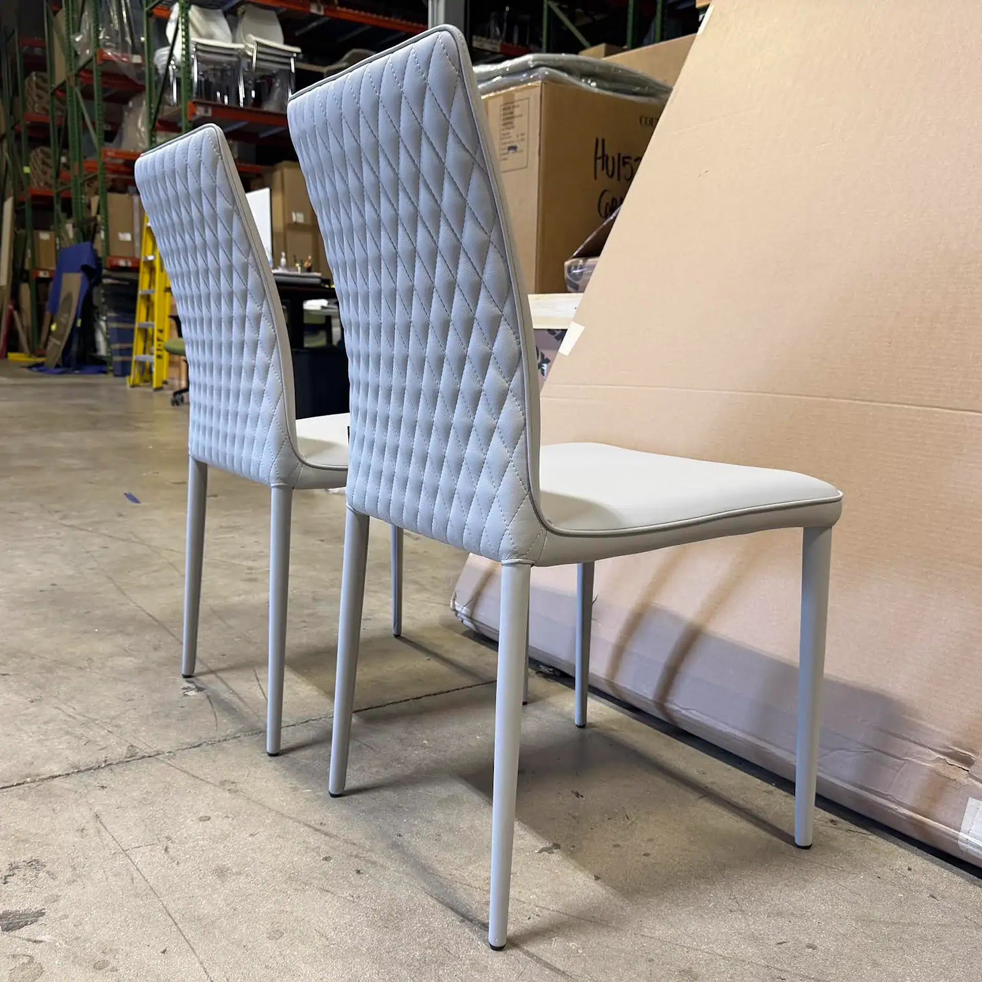 Shefi Quilted Dining Chairs with diamond stitching in a warehouse setting.