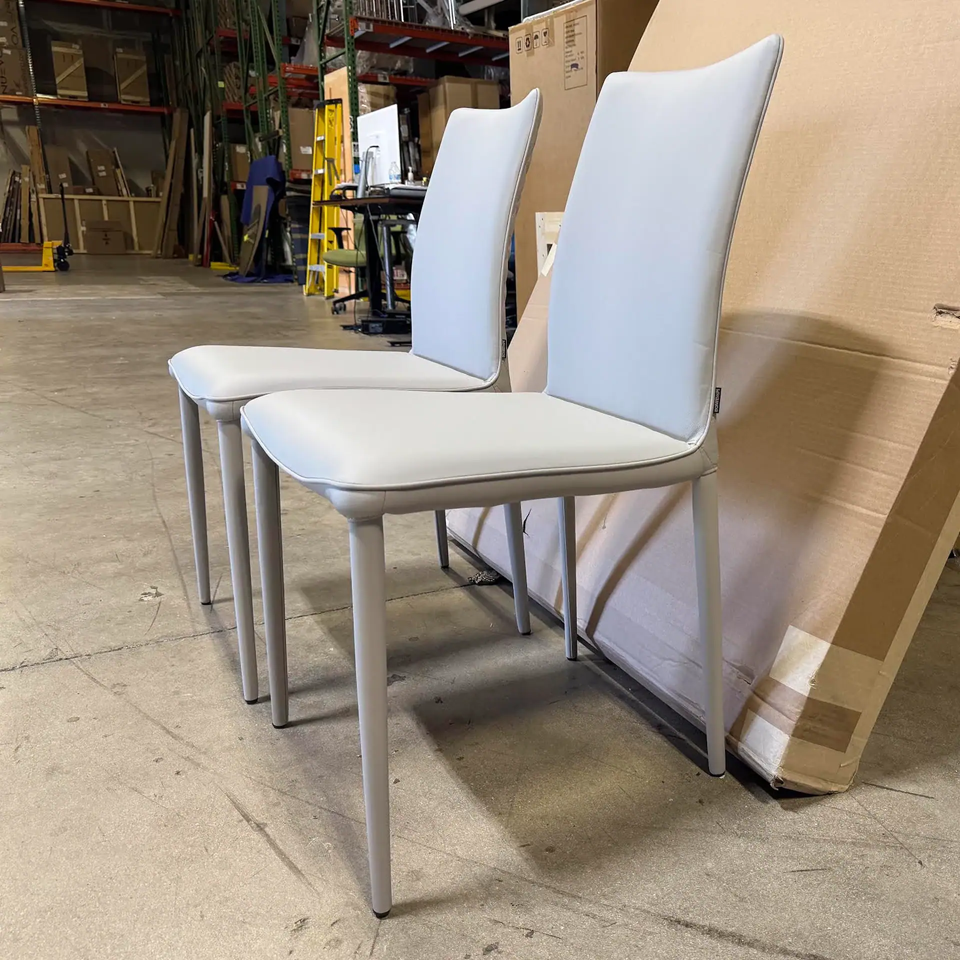 Pair of Shefi Quilted Dining Chairs in a warehouse setting.