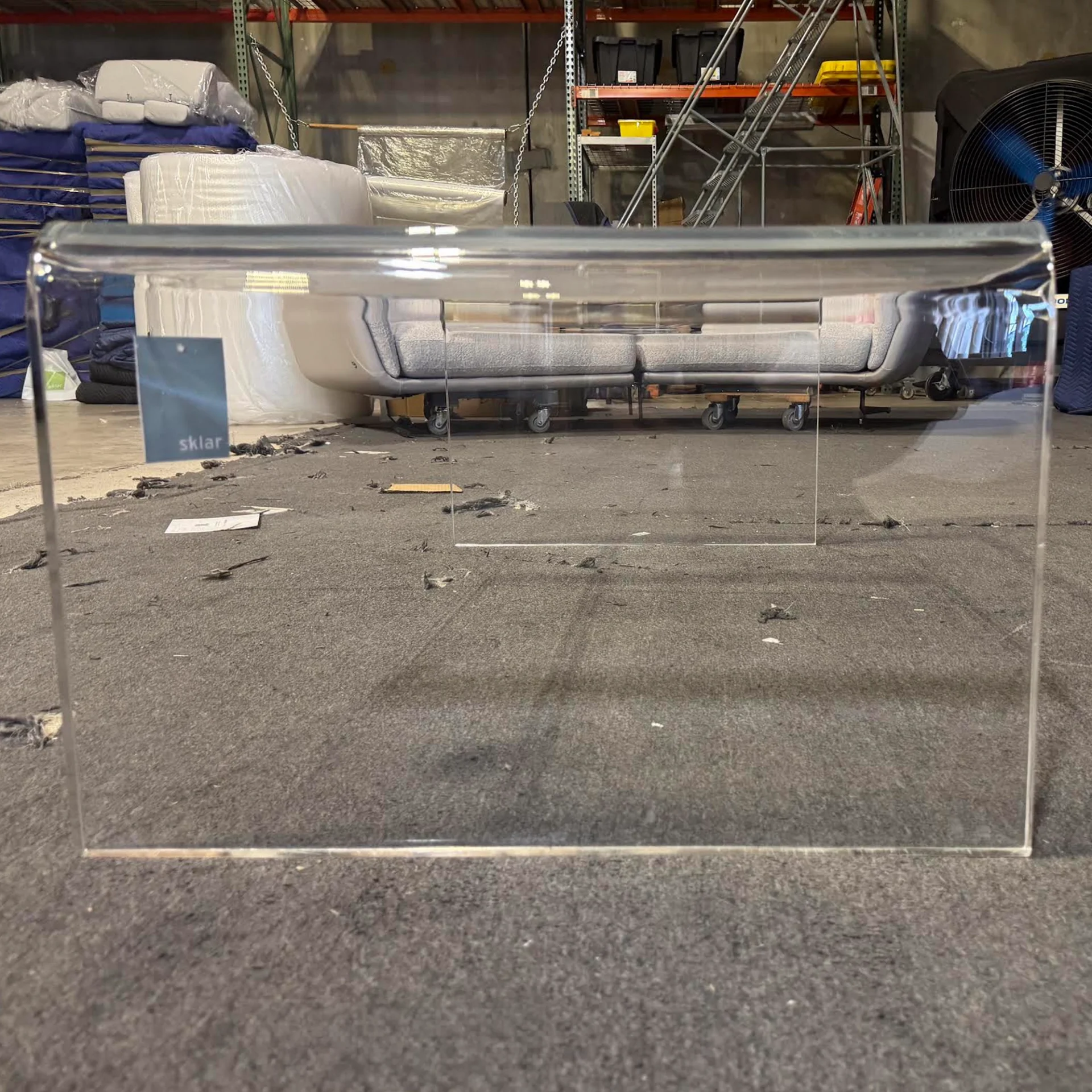 Euro Style acrylic coffee table in warehouse setting.