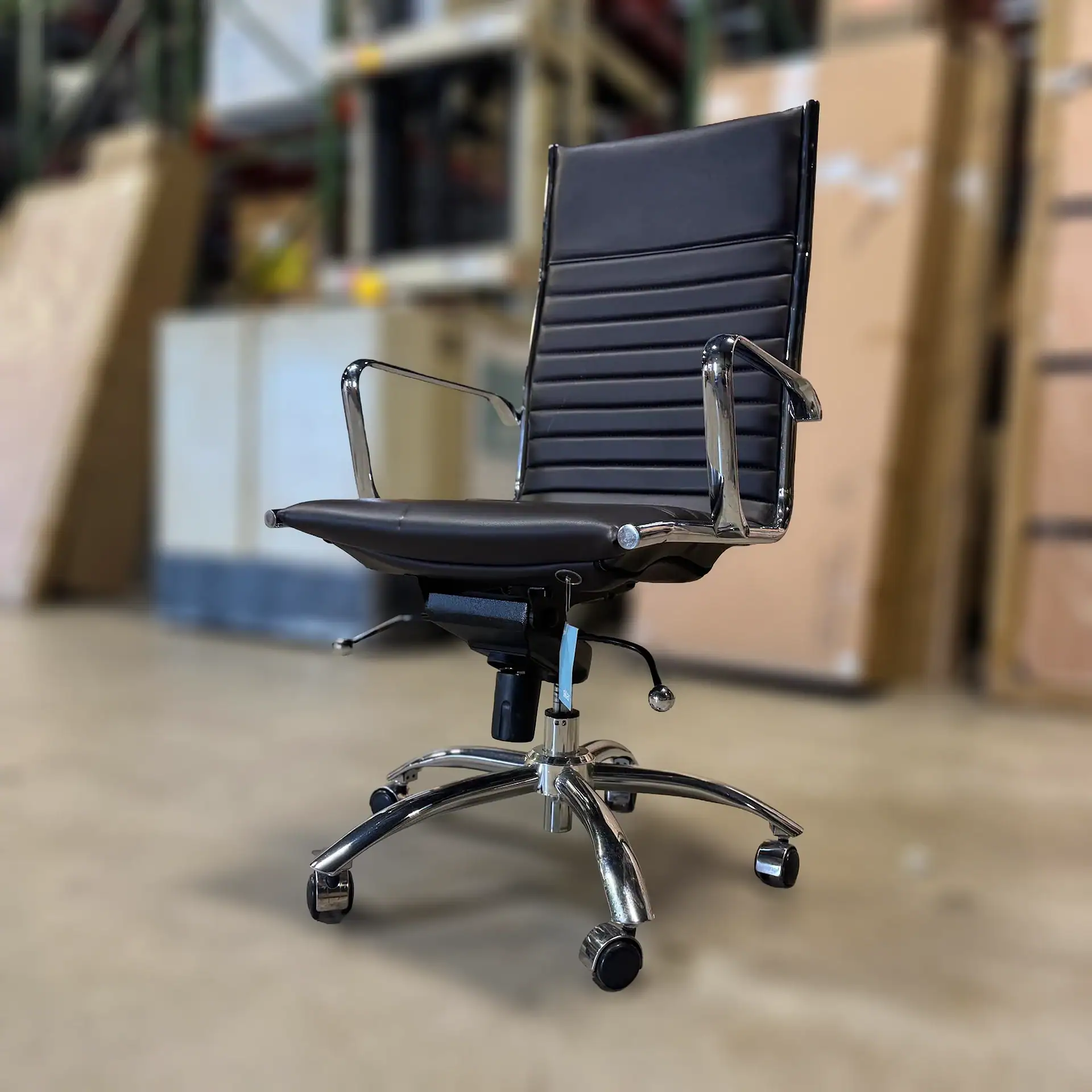 Euro Style Dirk high back office chair with armrests in a warehouse setting.