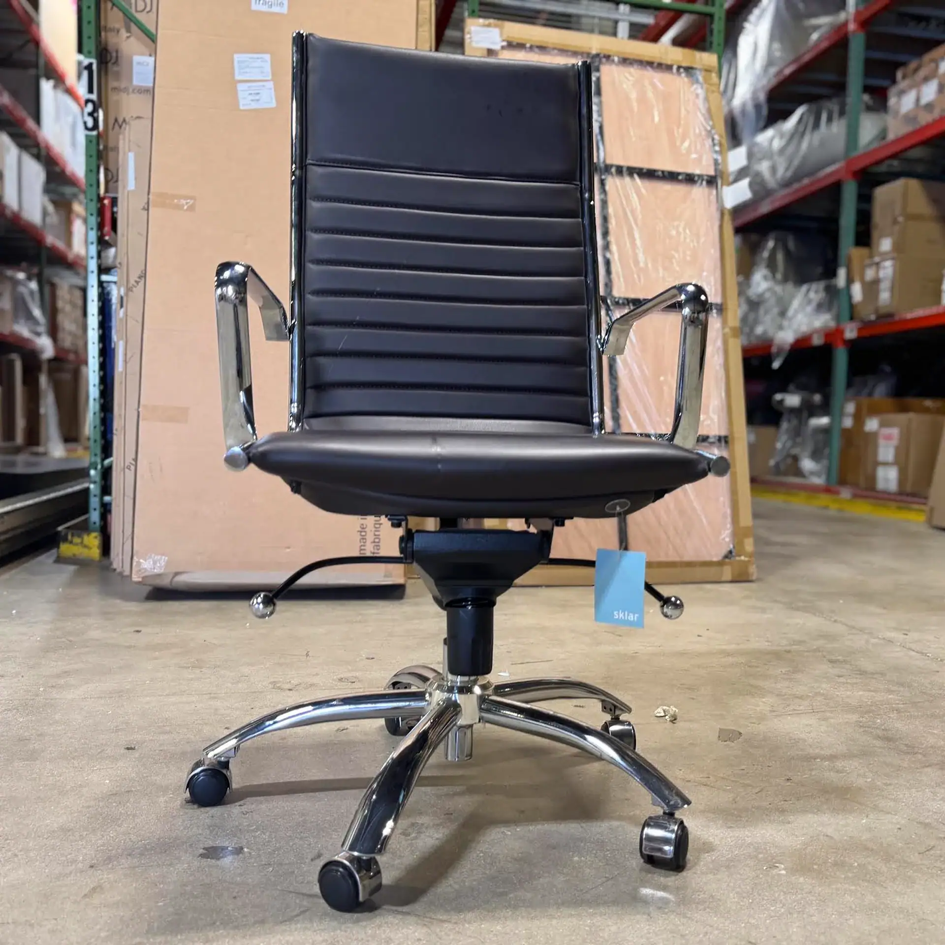 Euro Style Dirk high back office chair with black leather and chrome arms.