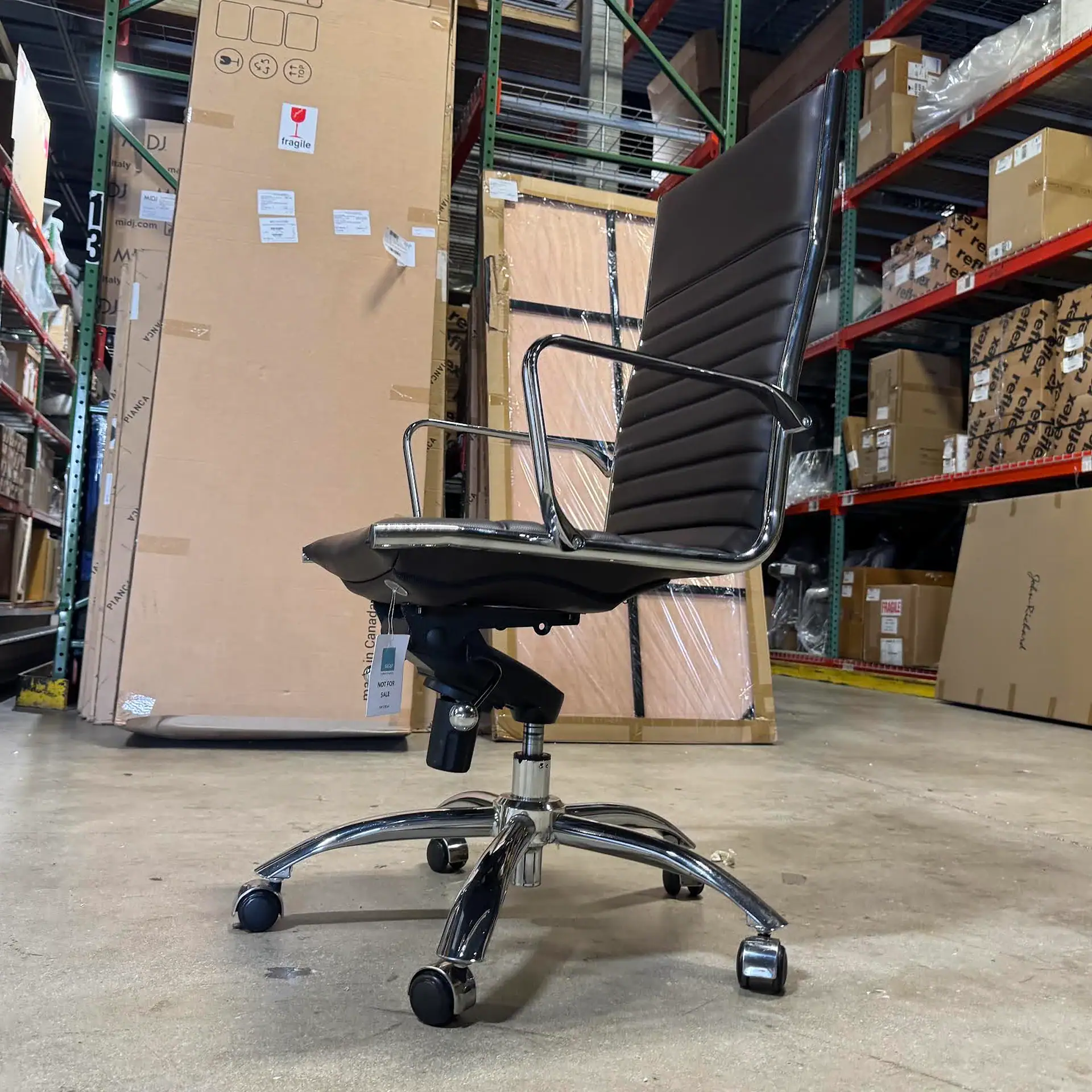 Euro Style Dirk high back office chair with armrests in warehouse setting.