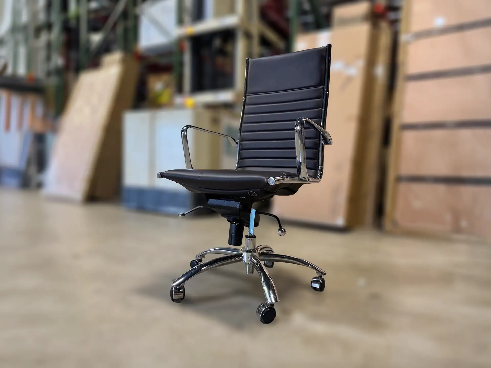 Euro Style Dirk high back office chair with armrests and black leather upholstery.