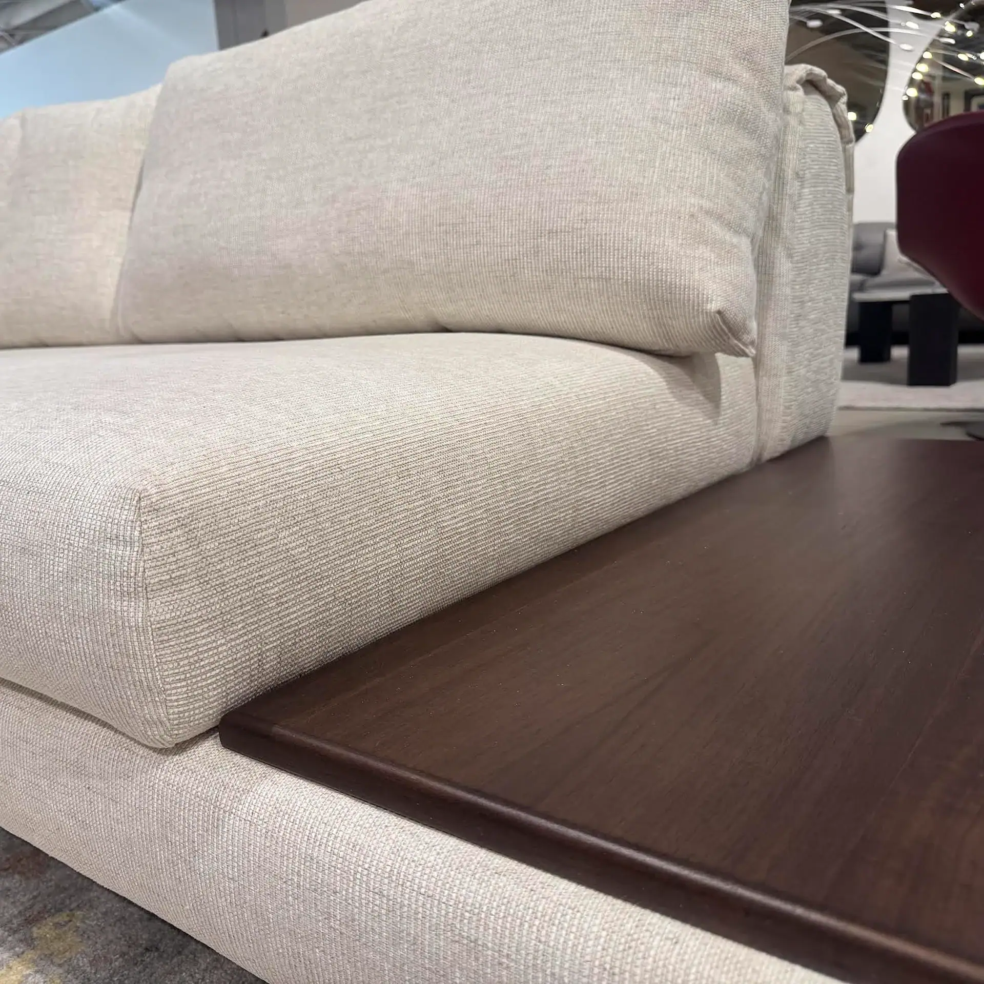 Nicoline Crumble Sectional Sofa with wooden side table in living room.