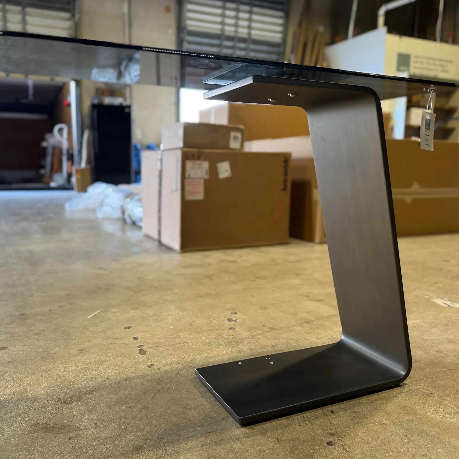 Reflex OH console table with black finish in warehouse setting.