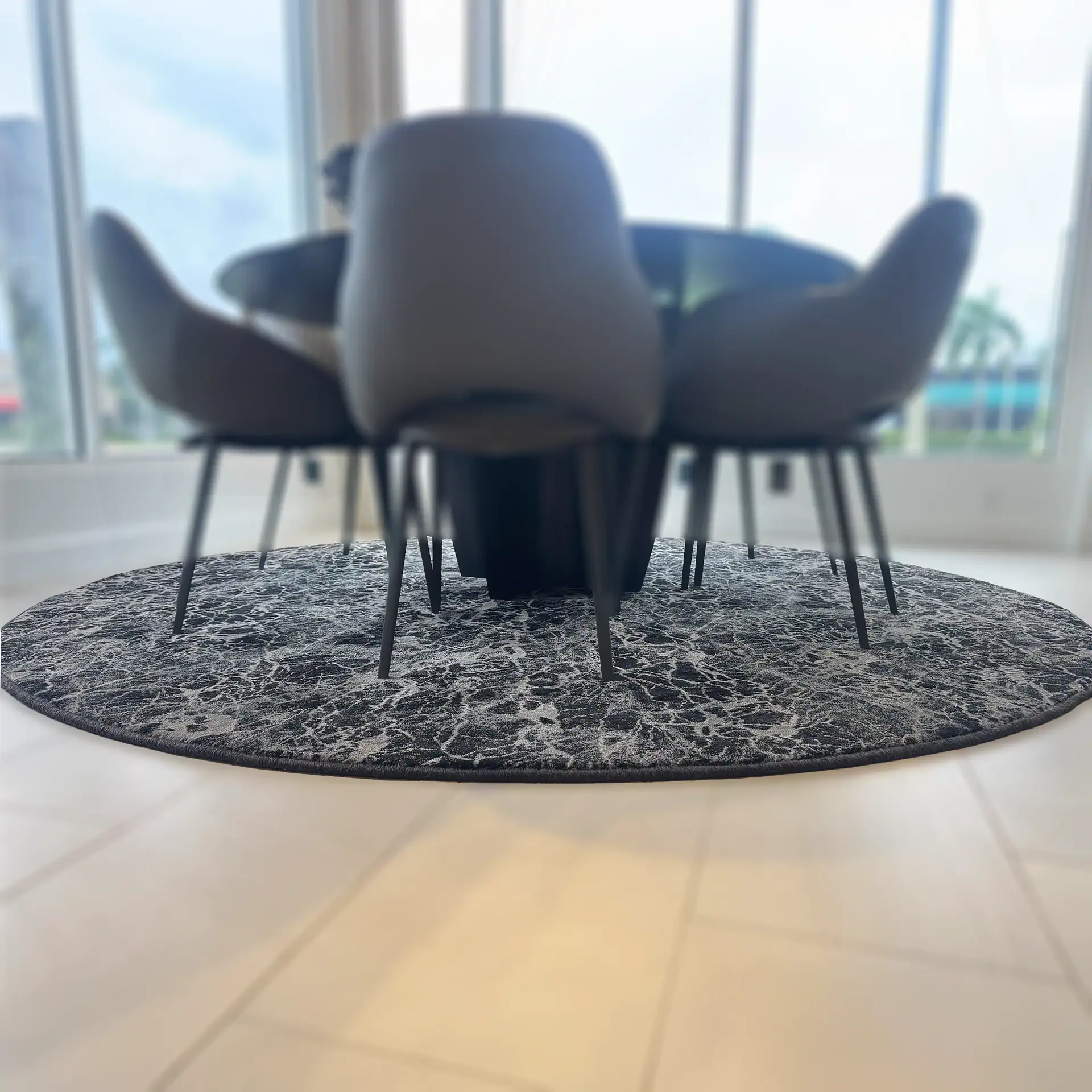 Stanton Zeus round rug under dining table in bright room.