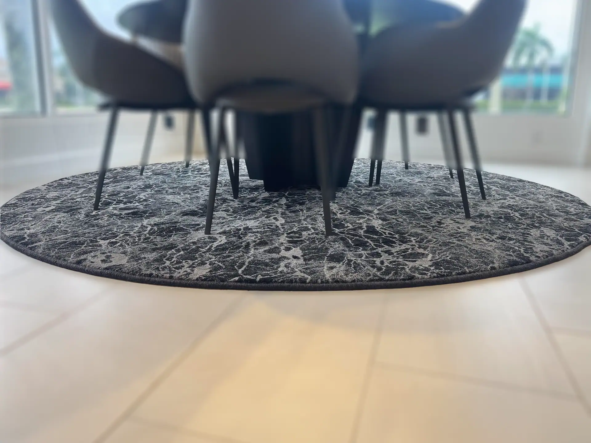Stanton Zeus round rug with a dark, textured pattern in a modern dining room.