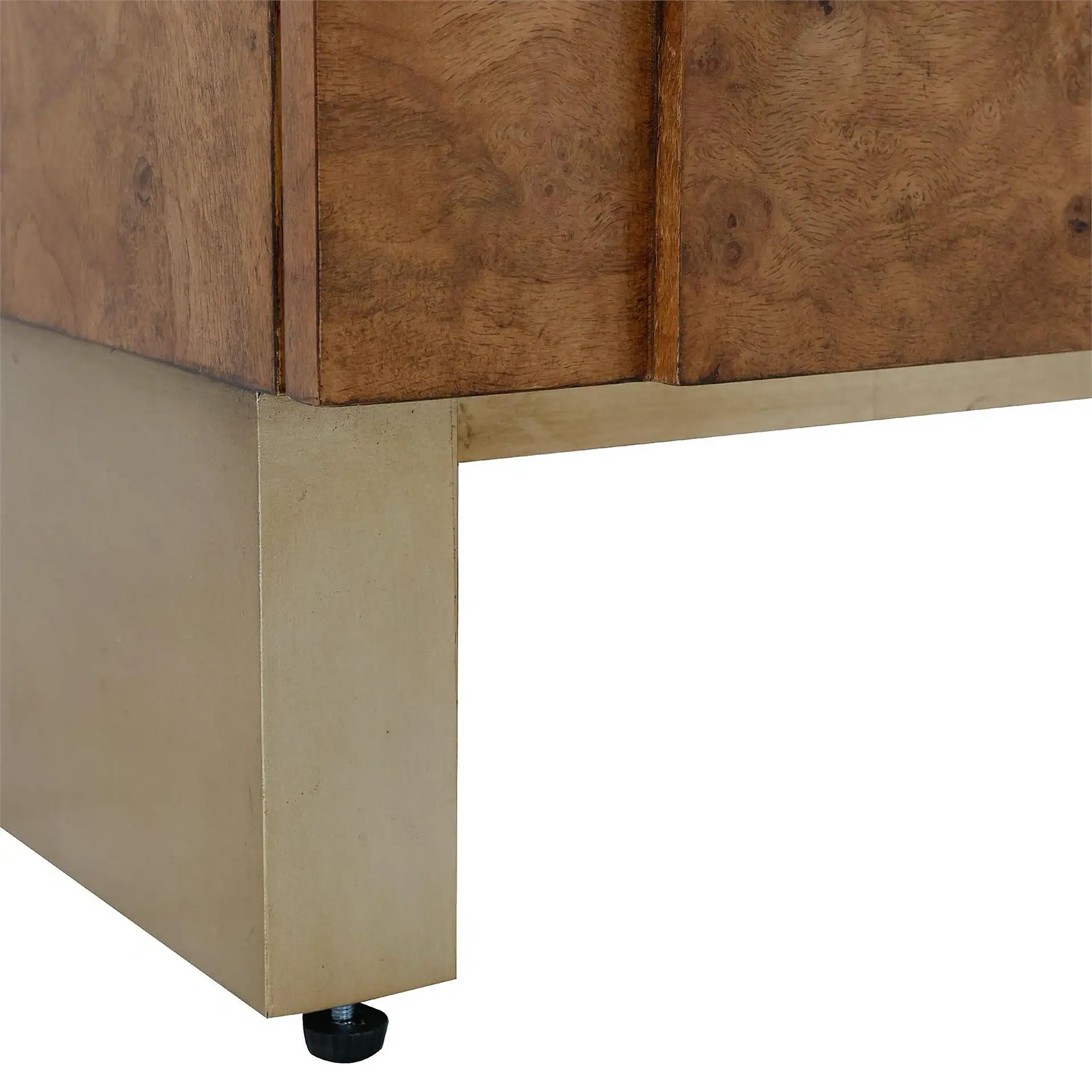 Bottom left corner of a wooden furniture piece with a metallic gold-toned base and a black adjustable leveling foot.