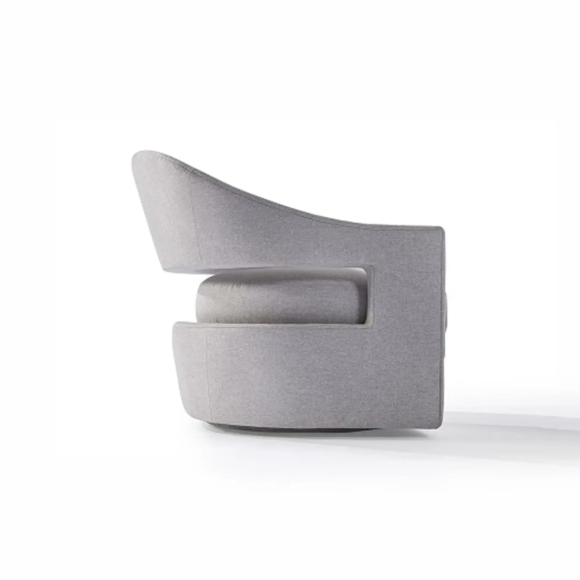 Side view of a light gray modern armchair with a curved back and a horizontal cutout revealing a lighter gray seat cushion.